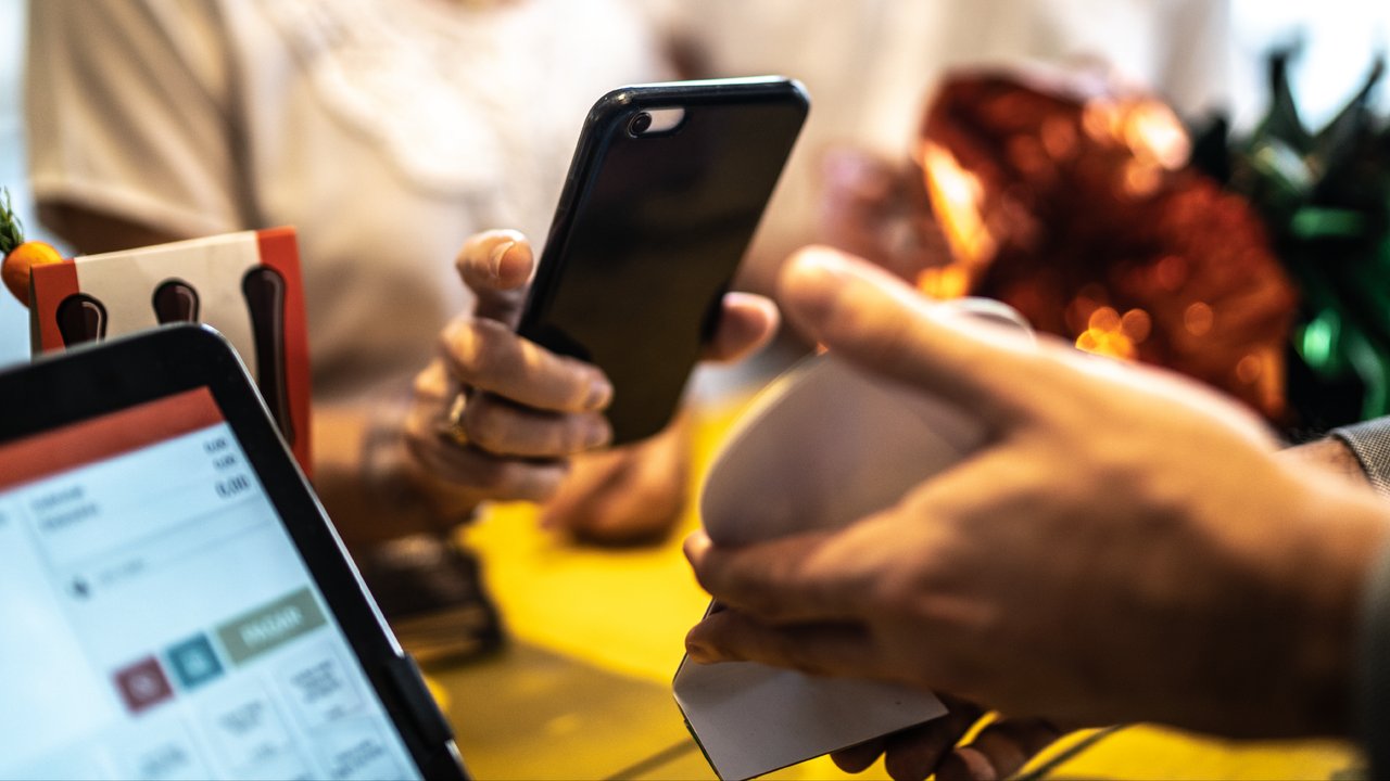 A person at a store paying by mobile
