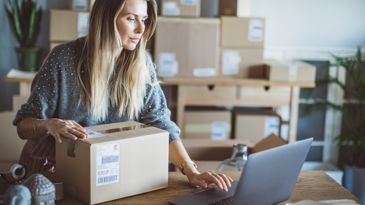Computer hackers wearing glasses and using a computer in a dark room