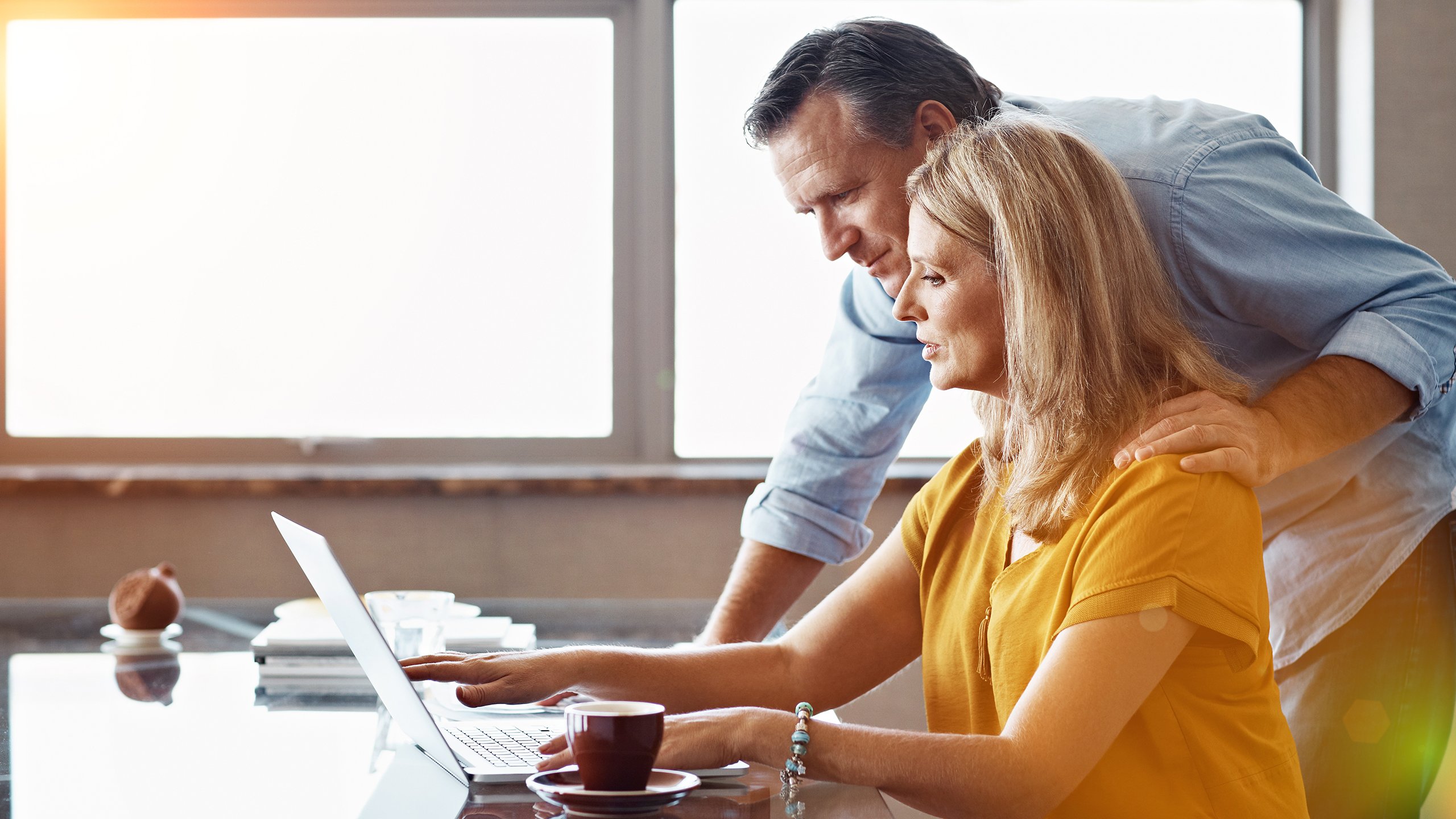 A couple reporting a claim online using a laptop