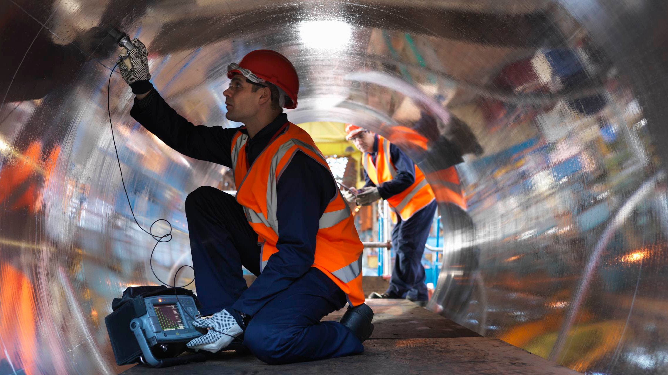 Equipment Inspections What you need to know Two men wearing a hard hat and protective gear, inspecting forged steel