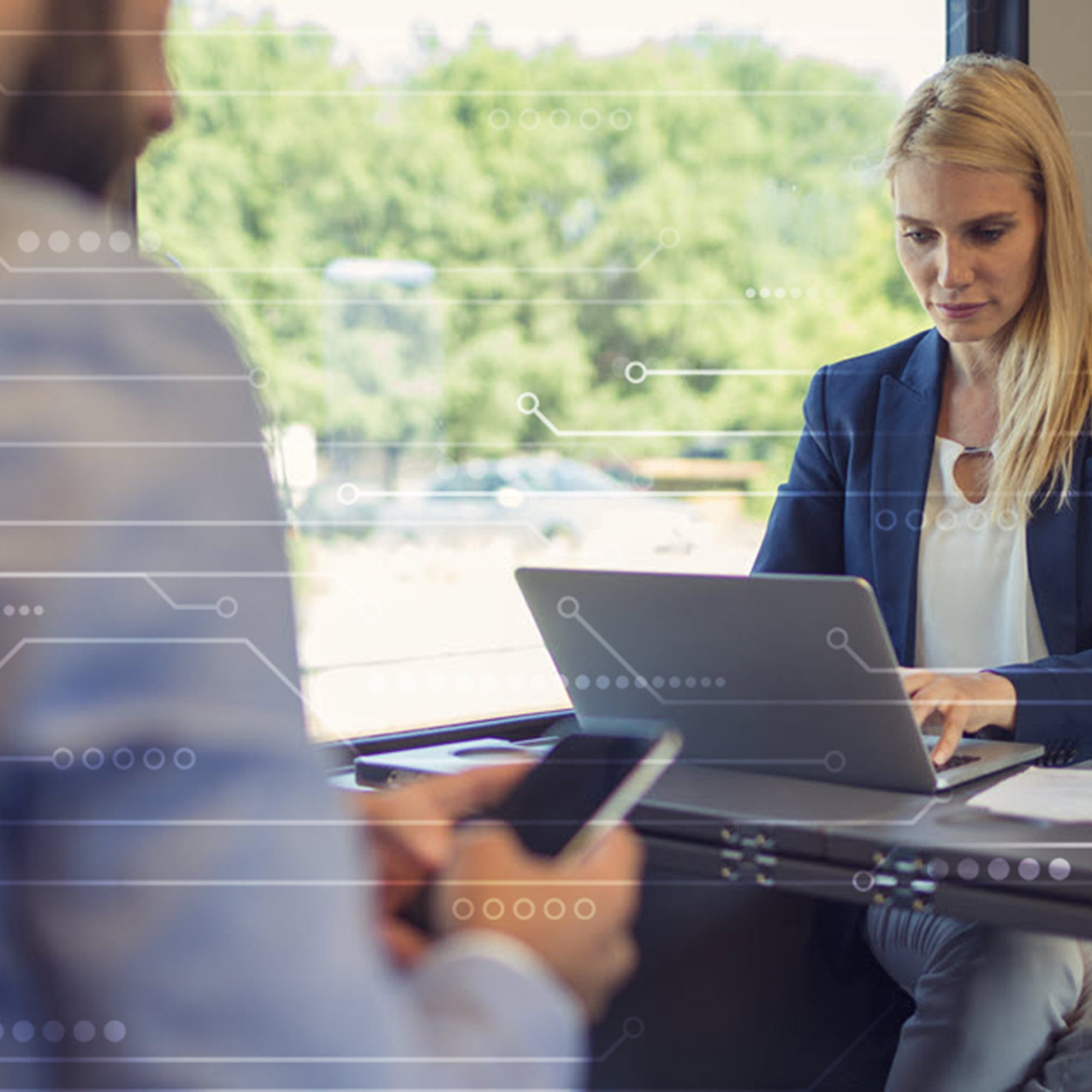 The role of business computer insurance in an evolving digital world Woman using a laptop on a train