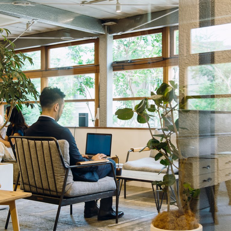 Man using a laptop in a hybrid working environment