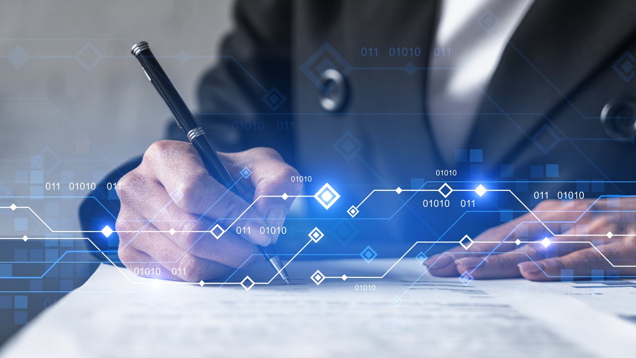 A person writes with a pen on paper, with digital data graphics overlaying the scene.