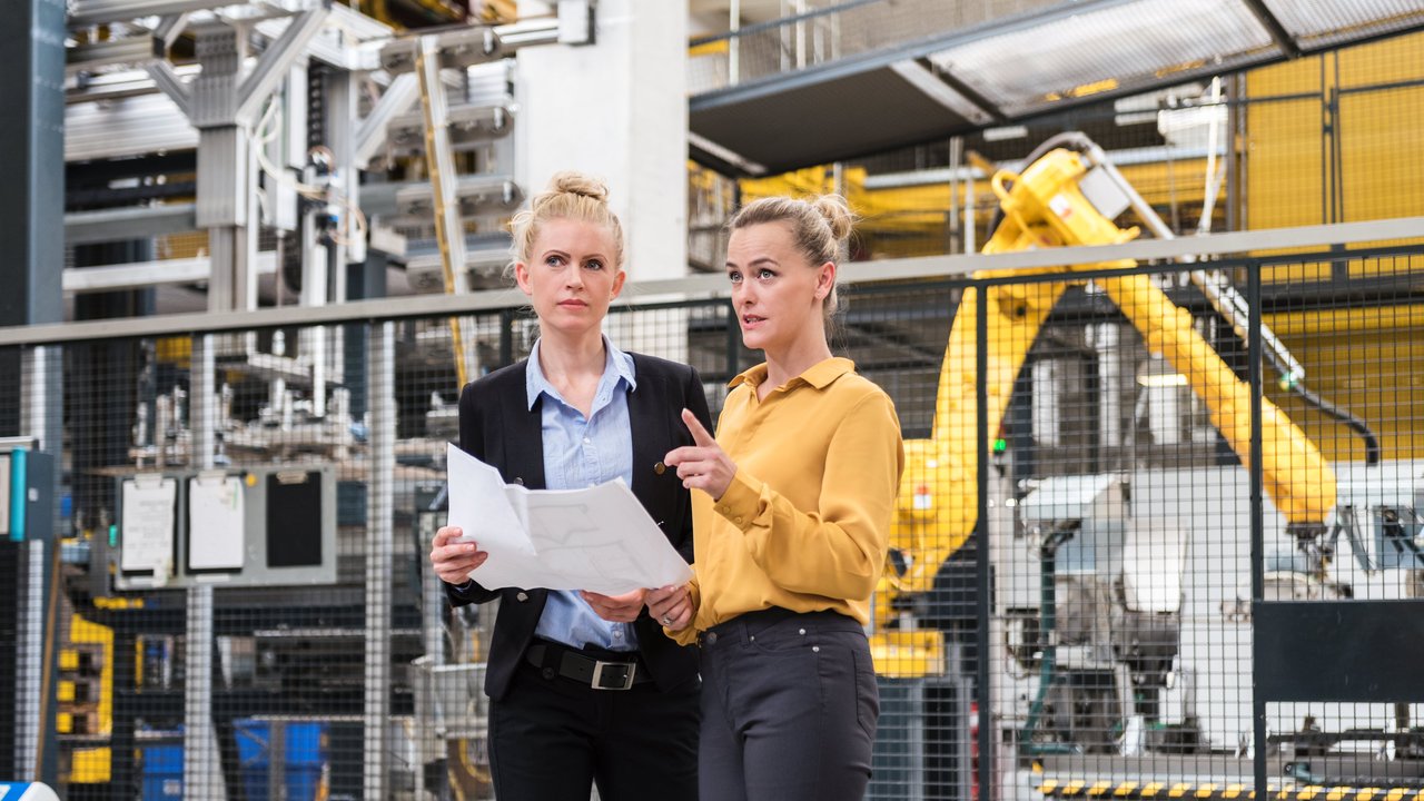 Two women in a factory