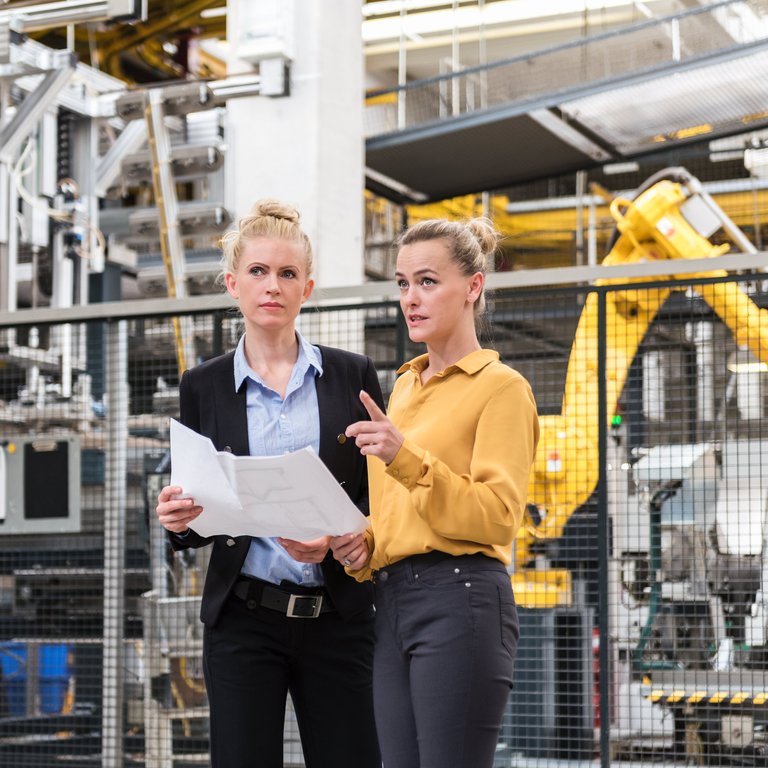 Two women in a factory setting