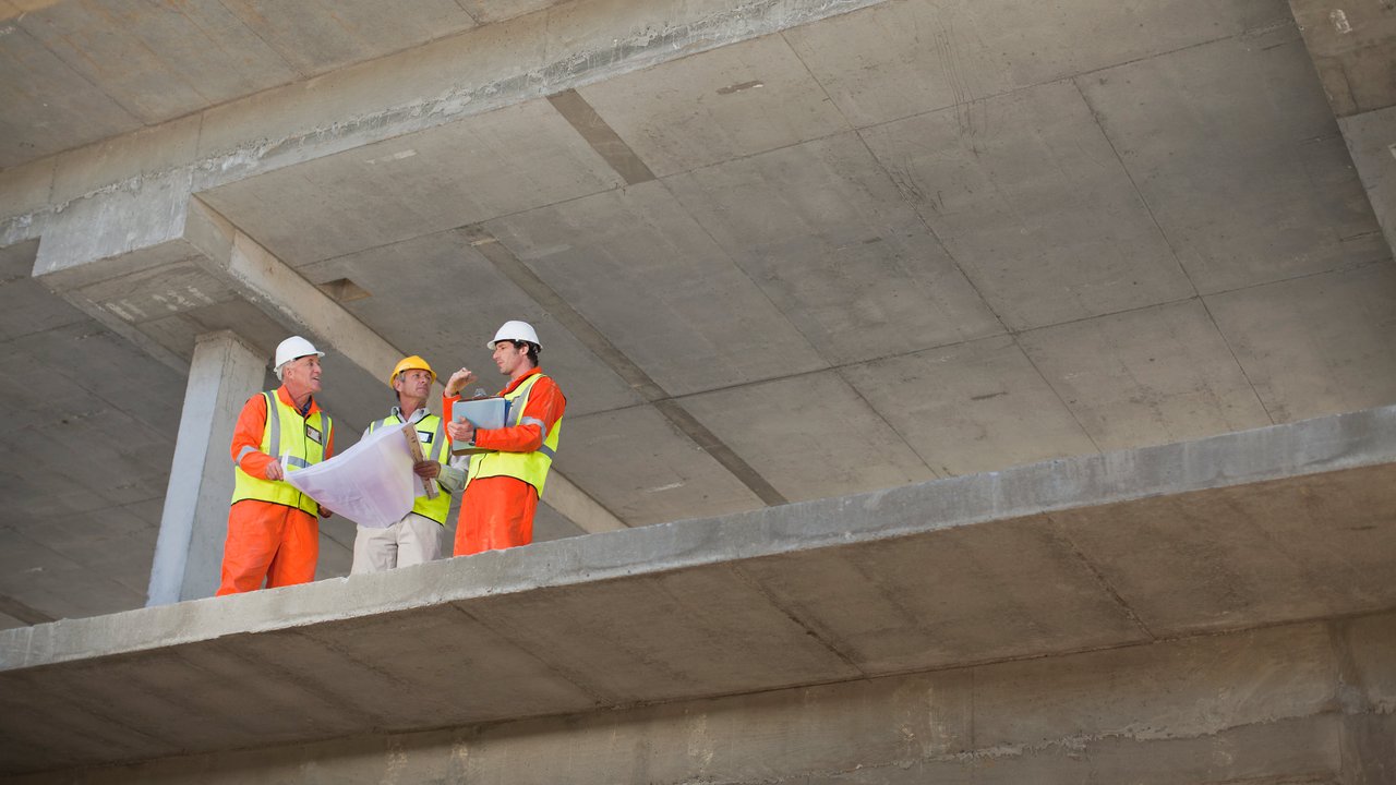 Three construction workers on a construction site