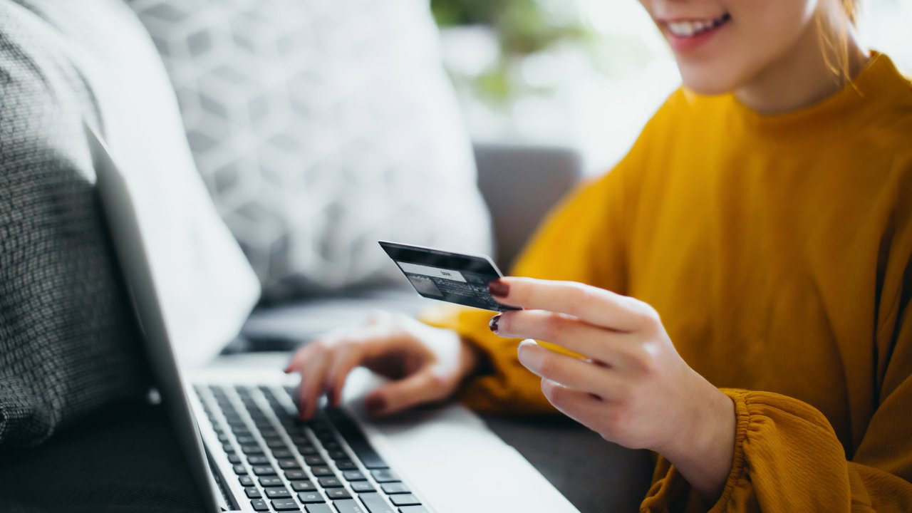 A woman making a credit card payment via her laptop