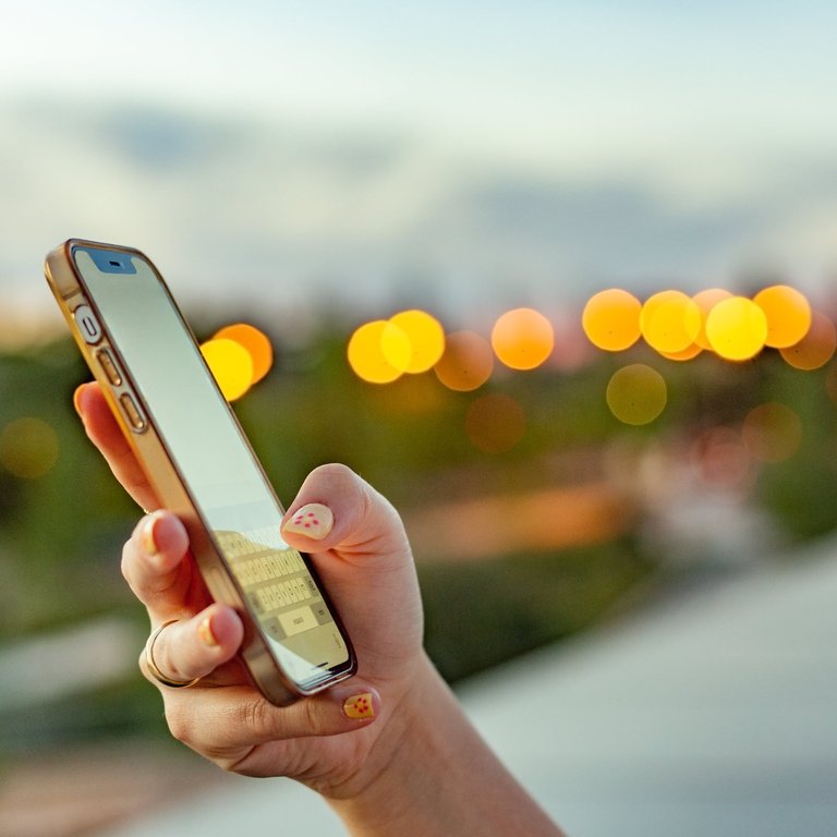 A woman's hand holding a mobile phone