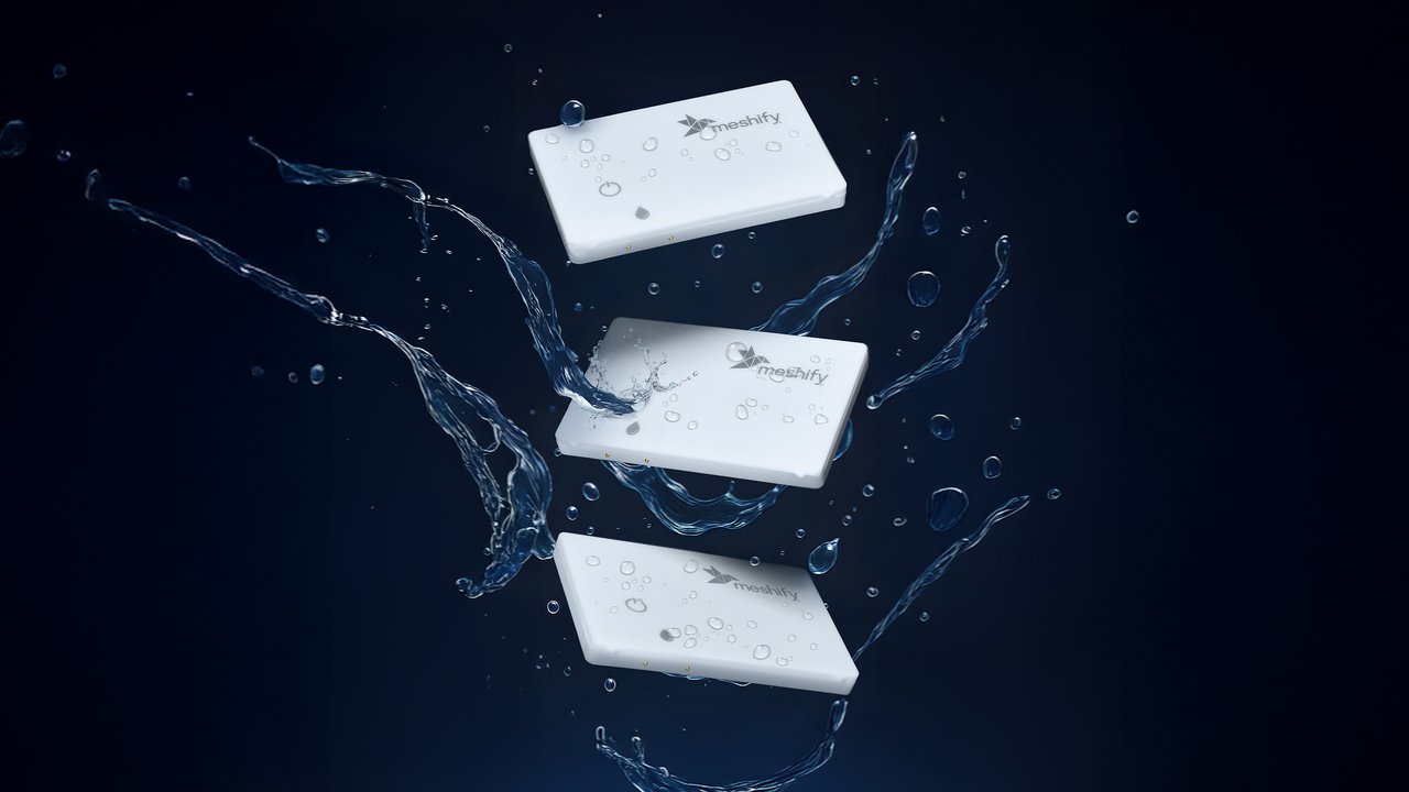 Floating Soap Bars with Water Splash Three white rectangular objects are suspended in mid-air, surrounded by splashes of water. The background is a deep black, enhancing the contrast and highlighting the droplets glistening on the surfaces of the objects. The scene conveys a sense of freshness and cleanliness, evoking a dynamic, fluid motion.