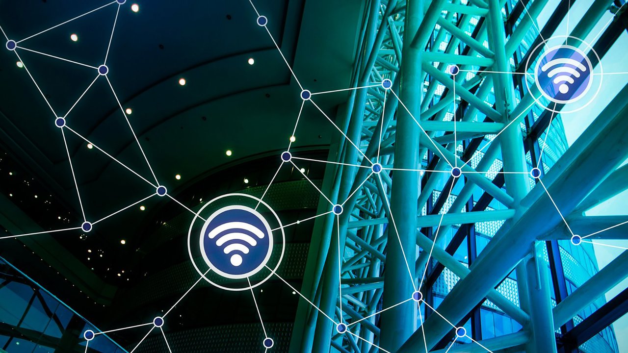 Commercial IoT Occupancies A modern architectural interior features a network of interconnected lines and nodes, symbolizing digital connectivity. Stylized Wi-Fi icons are scattered throughout, set against a backdrop of sleek, angular structures and large glass windows. The color palette blends deep blues and greens, creating a dynamic, tech-inspired atmosphere.