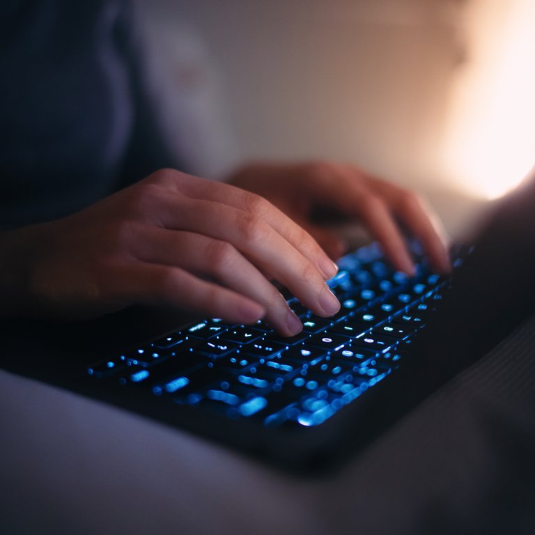 A person typing on a laptop