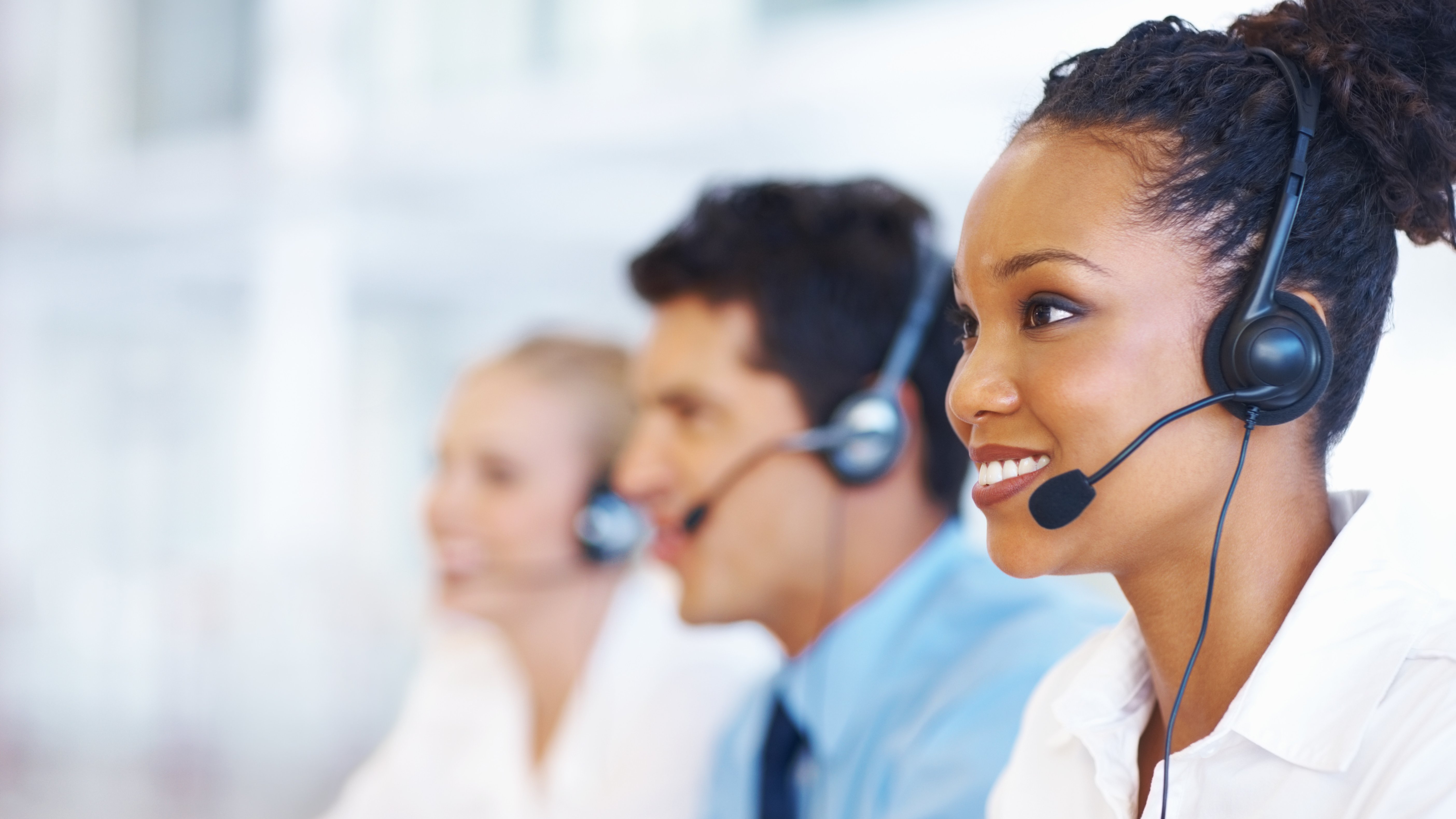 customer service person wearing headset looking at computer monitor