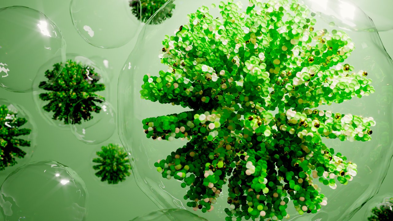 Digital generated image of green drops of liquid or hydrogen molecules inside transparent spheres.