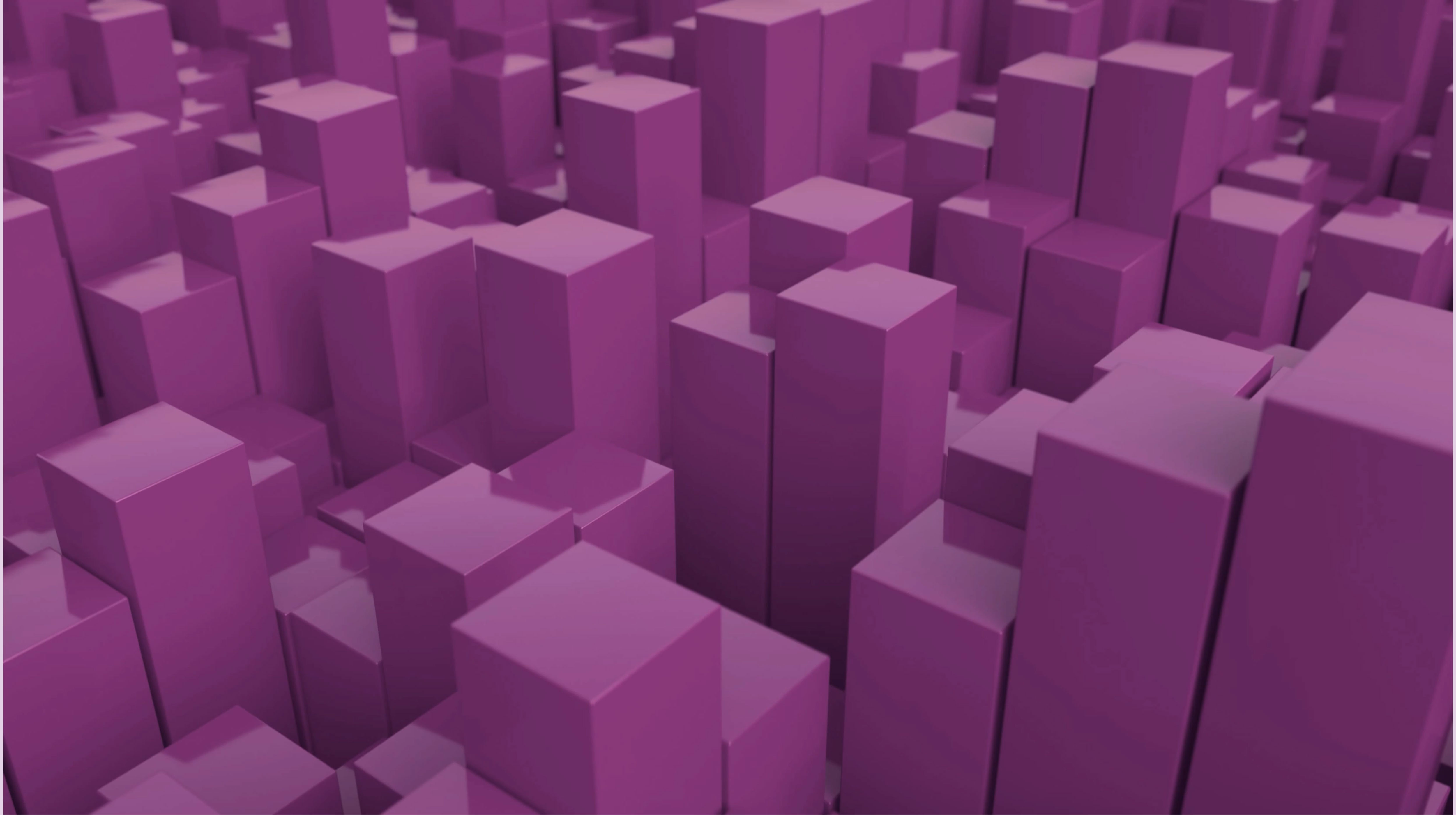 A vibrant landscape of three-dimensional, glossy purple blocks varies in height and arrangement, creating a dynamic, abstract scene. The blocks are densely packed, with some partially obscured, adding depth and texture. Light reflects off the surfaces, enhancing the visual interest and creating a modern, digital aesthetic.