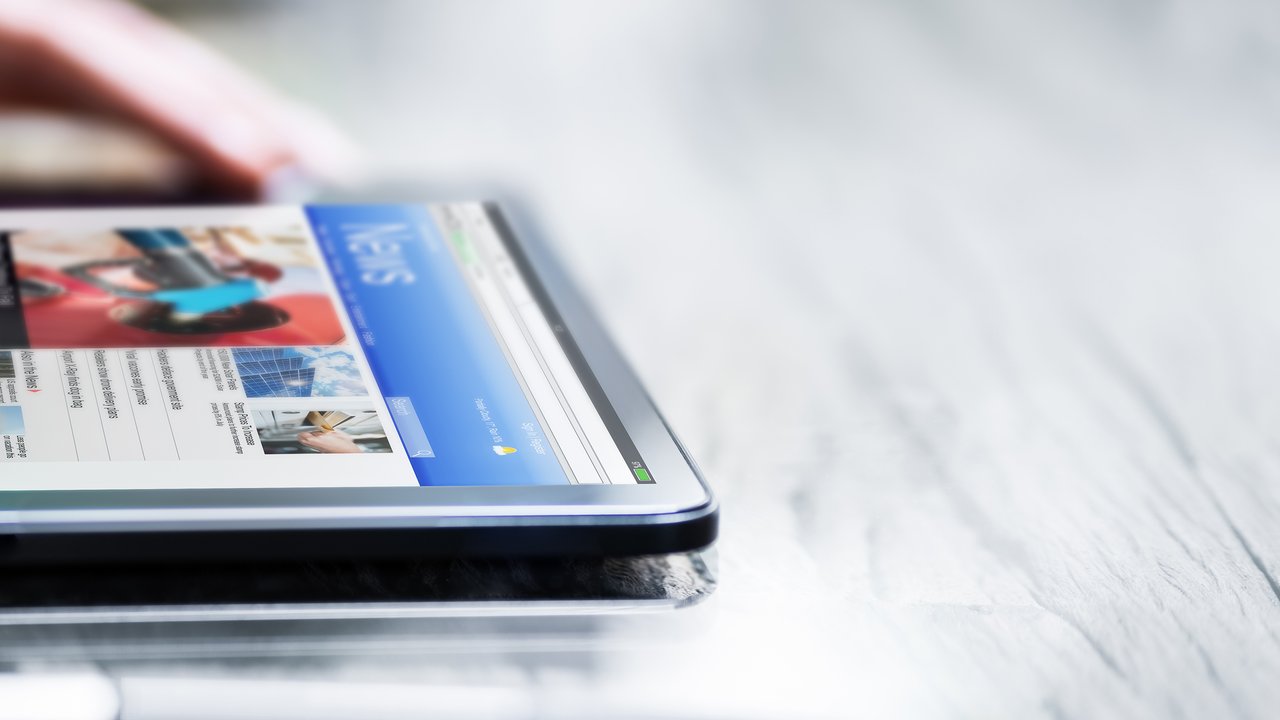 Reading Newspaper Article Online On Digital Tablet.