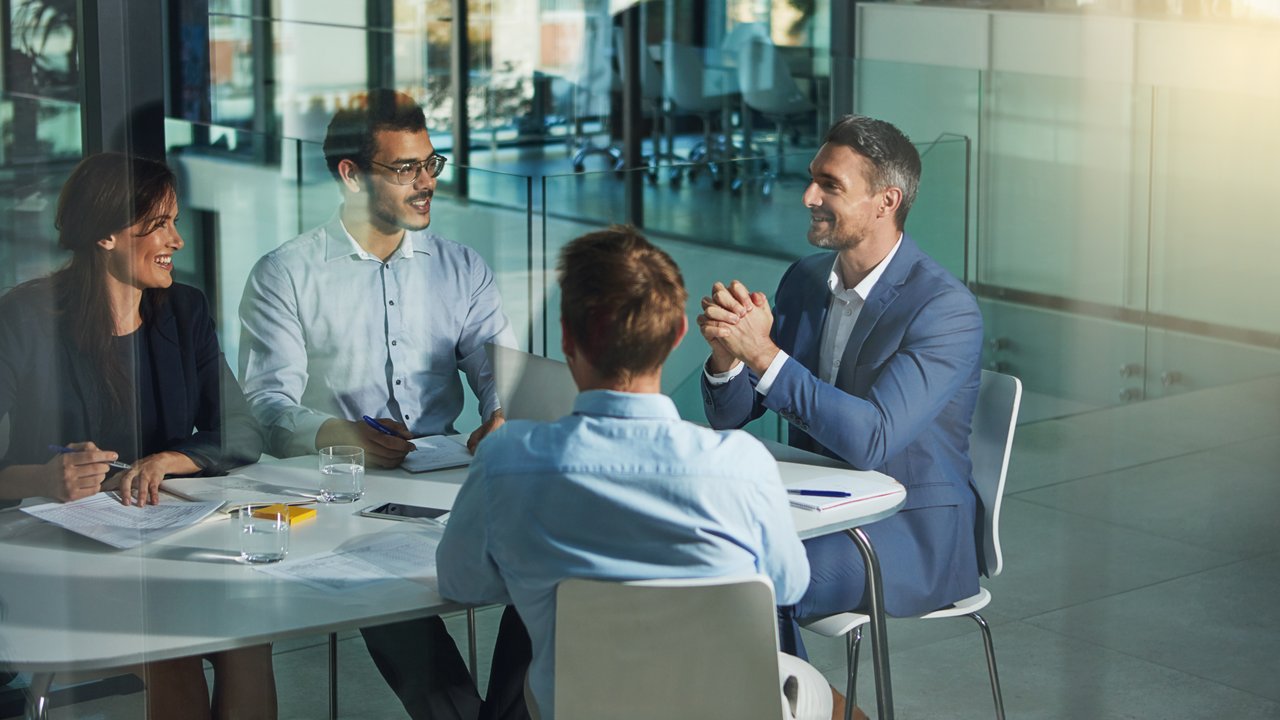 Colleagues collaborating in bright and open modern office meeting space