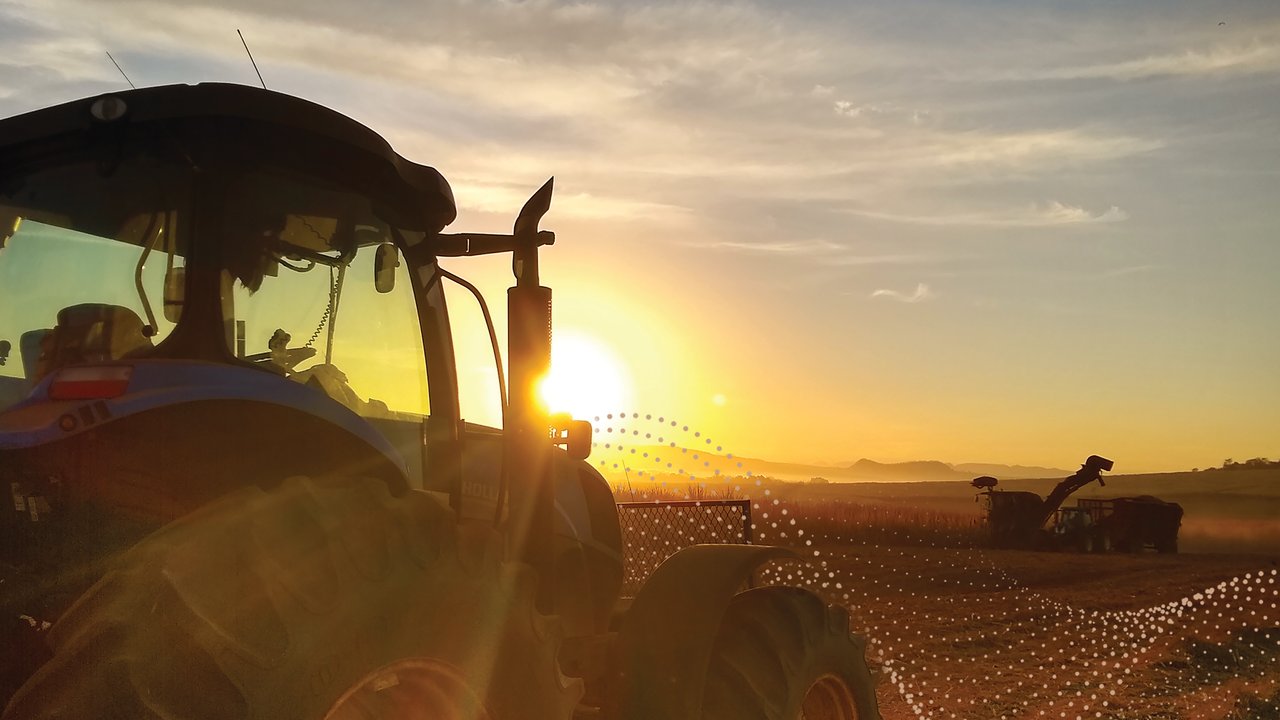 Farm Cyber Solutions Farm equipment in field at sunset