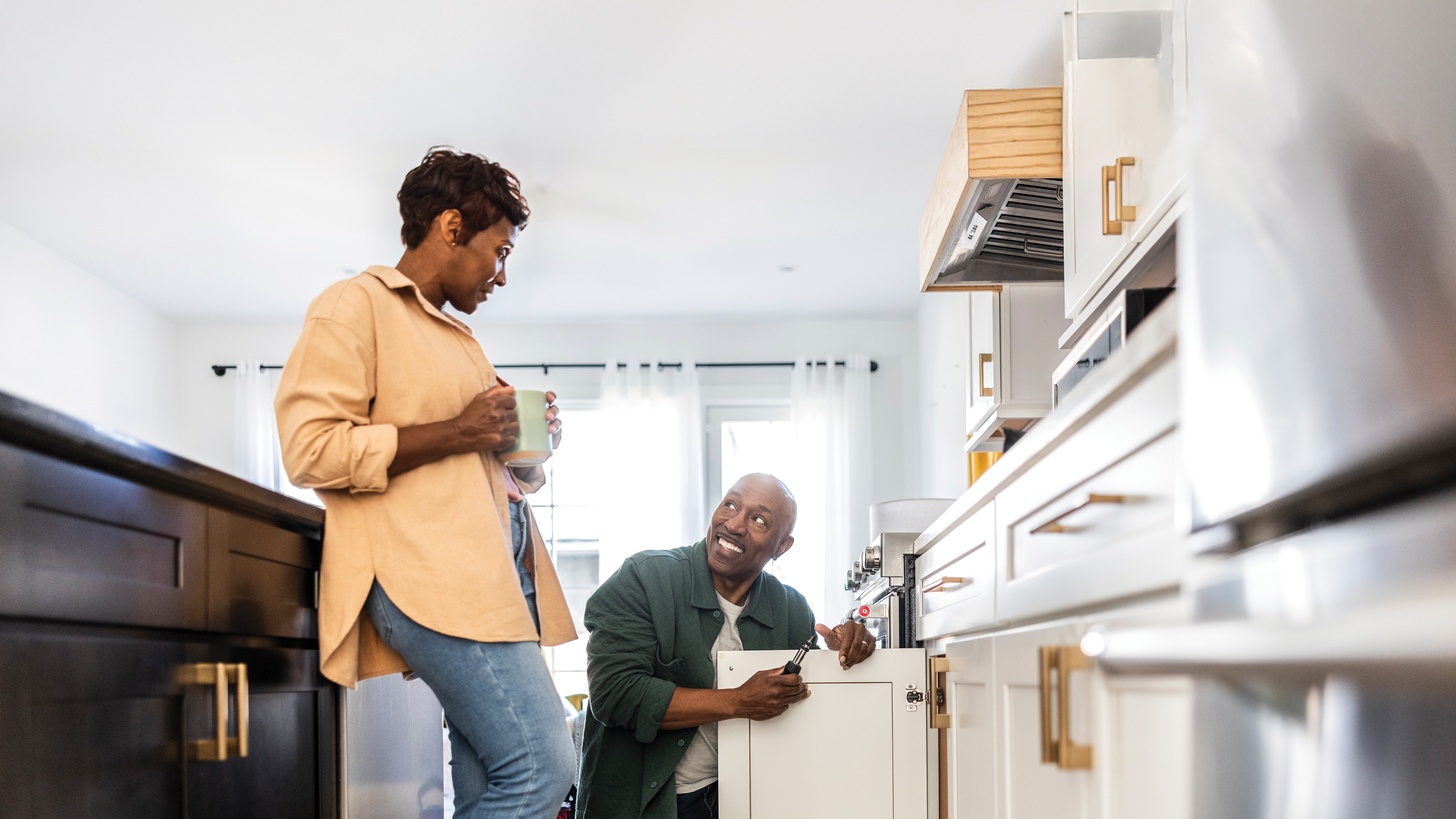 African american male and female working on kitchen improvements