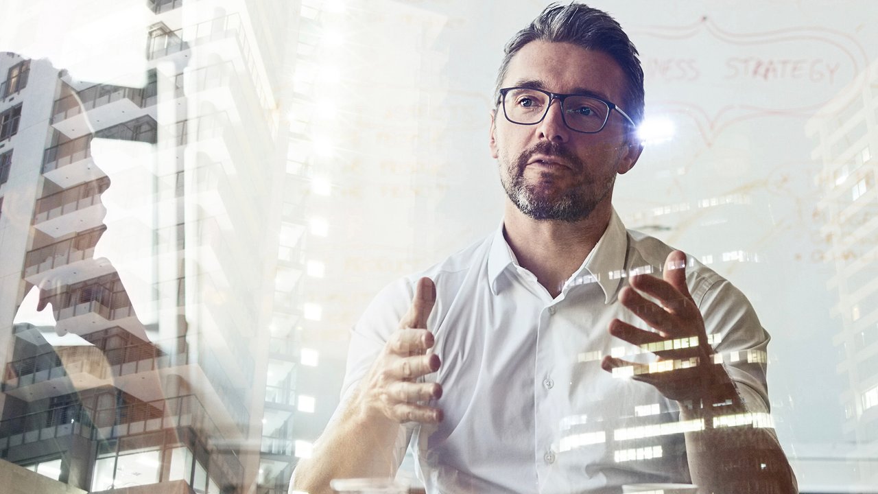 HSB MGA & Embedded Markets Co workers meeting with office building overlay