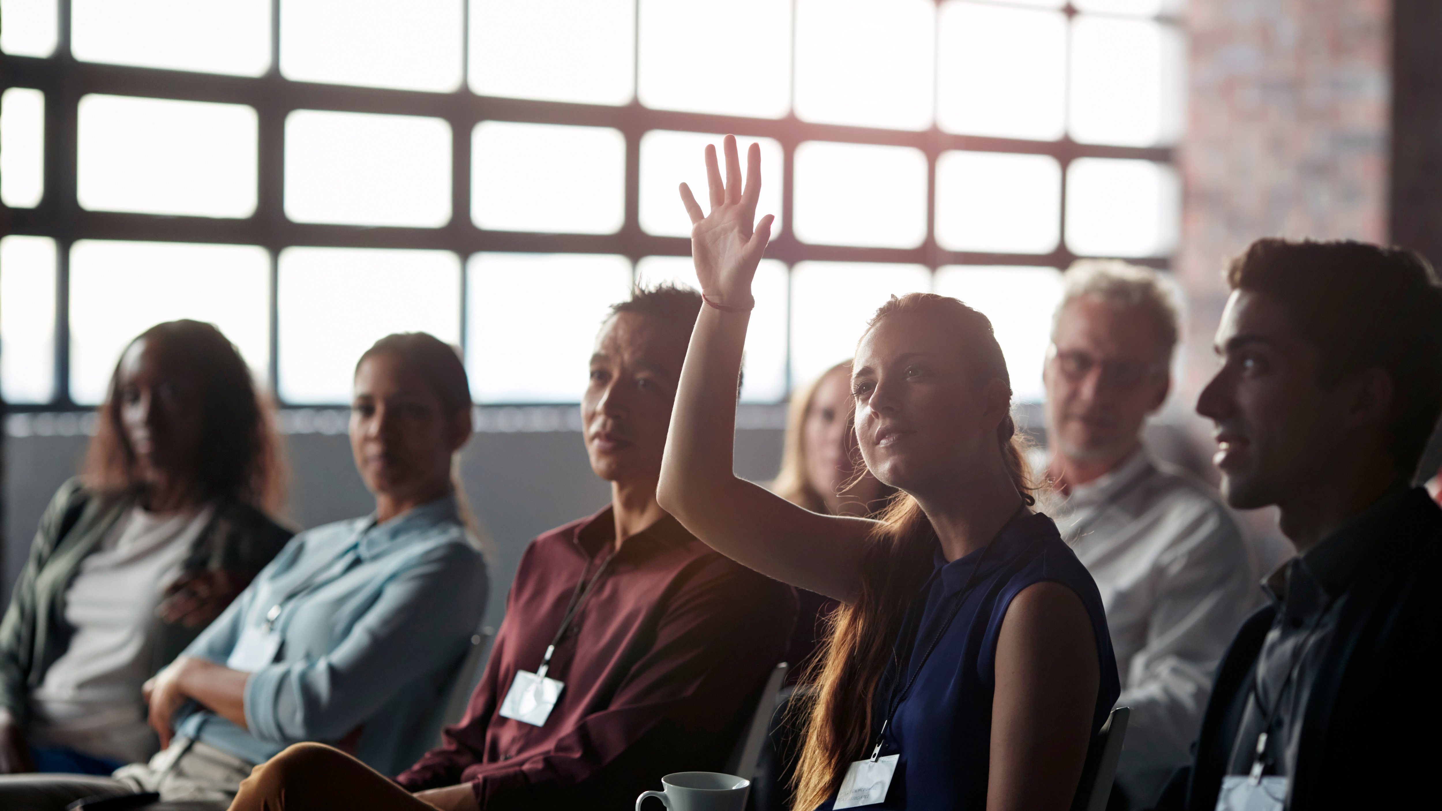 HSB Frequently Asked Questions Businesswoman with raised hand in professional group