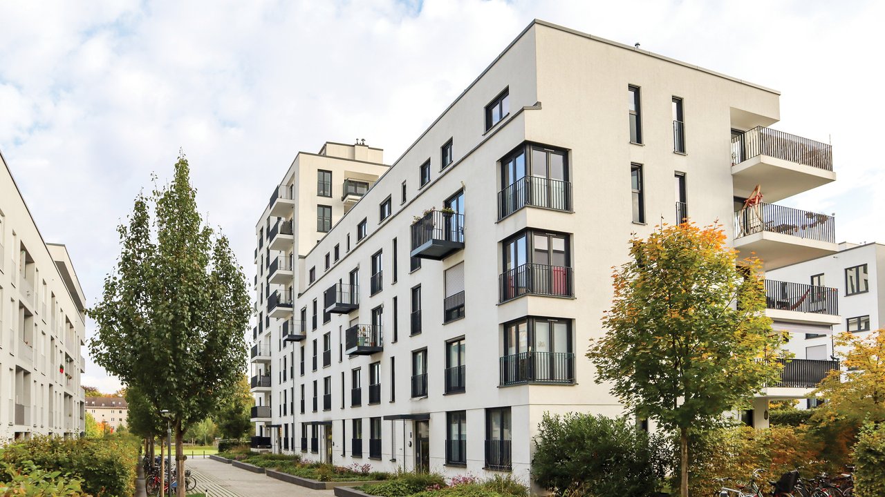 Meshify Assure: Guaranteed protection for your investment Cityscape with modern residential area, new apartment buildings and green courtyard with pavement and trees in autumn