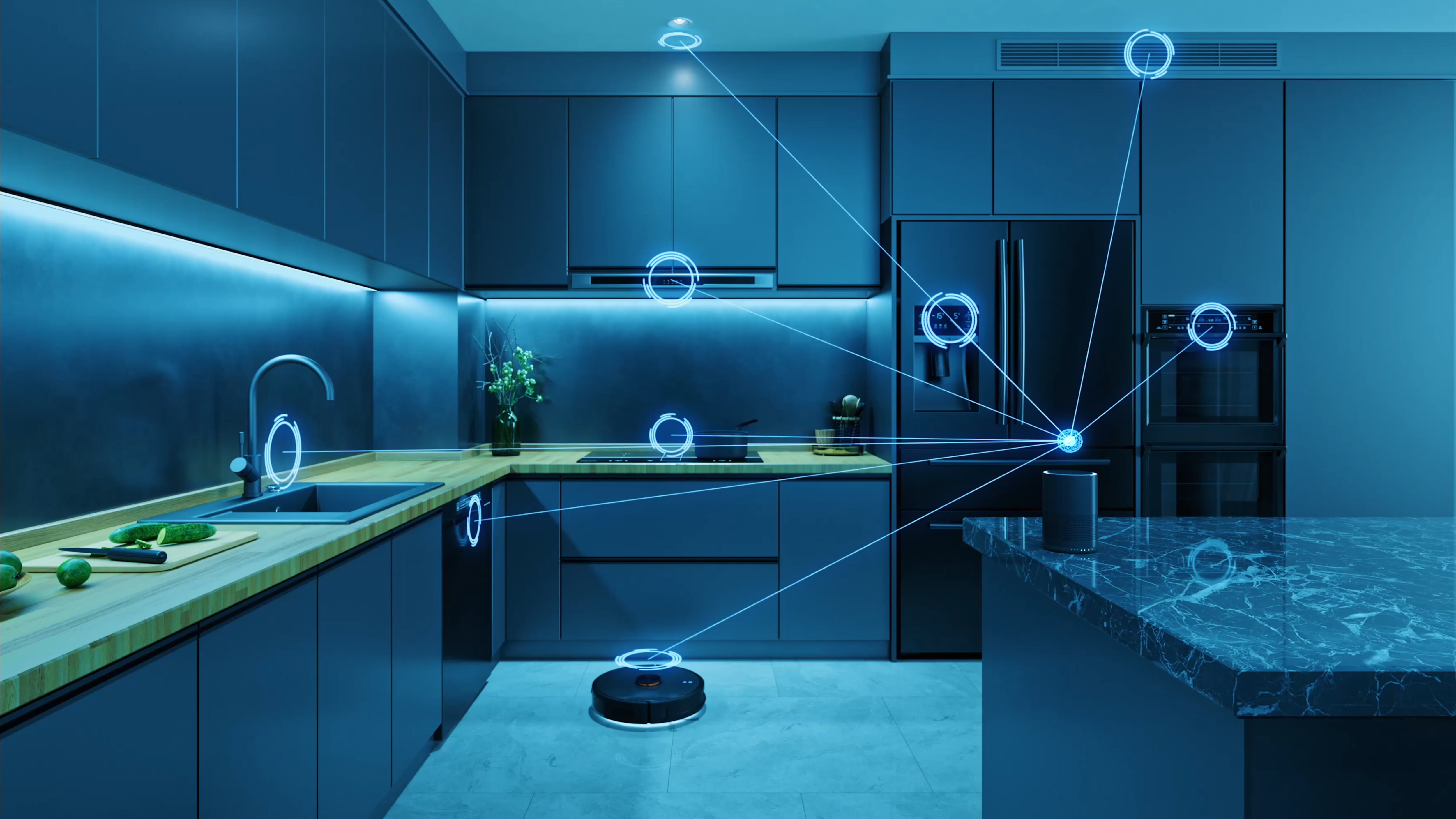 A modern kitchen features sleek, dark cabinetry and a marble countertop. A robotic vacuum is positioned on the floor, surrounded by glowing blue circles indicating smart technology connections. A cutting board with vegetables sits on the counter, and a small plant adds a touch of greenery, enhancing the contemporary atmosphere.