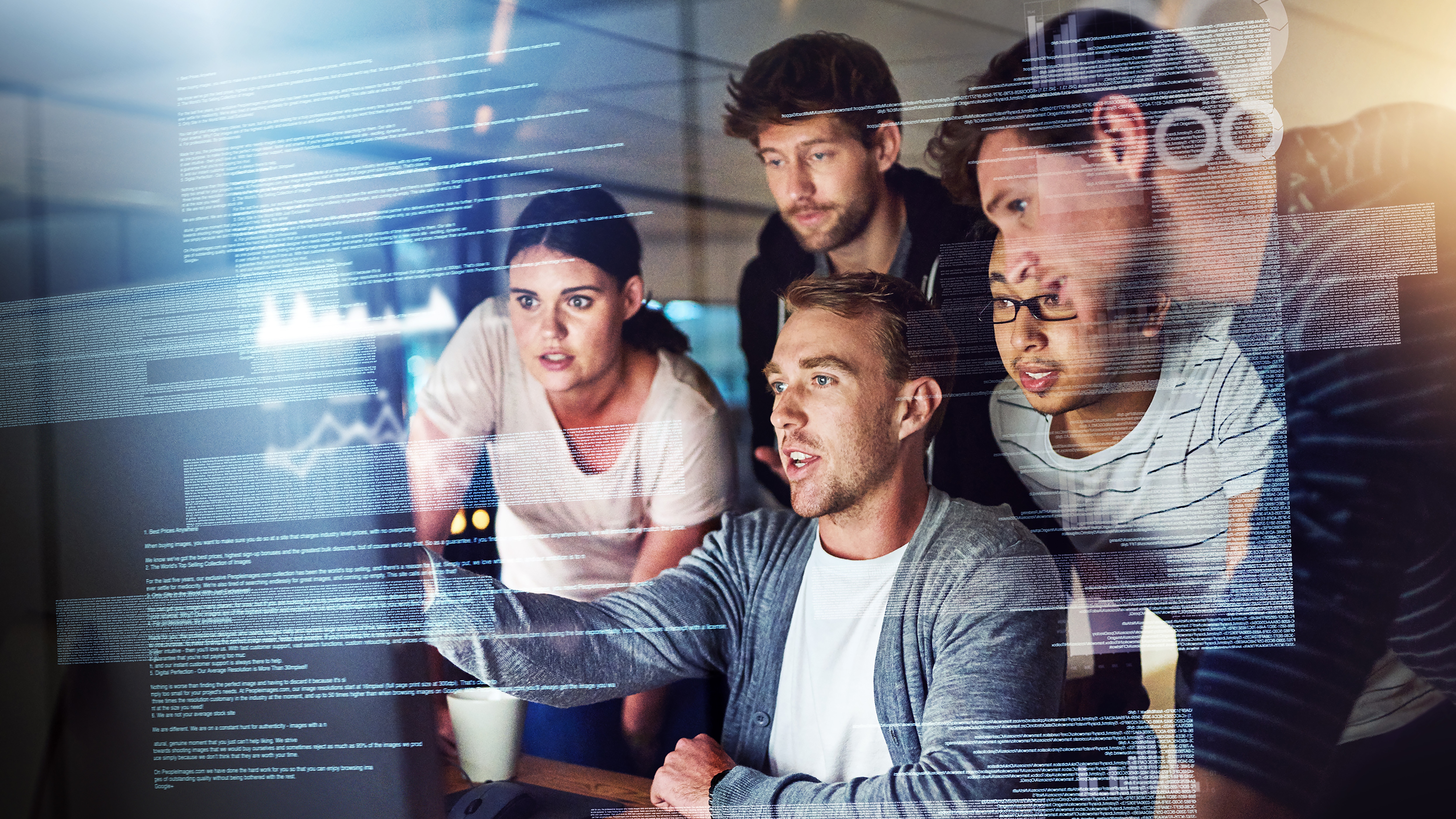 Group of people gathered around a computer screen