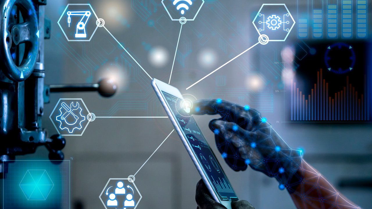 A hand interacts with a tablet displaying digital icons related to technology and connectivity.