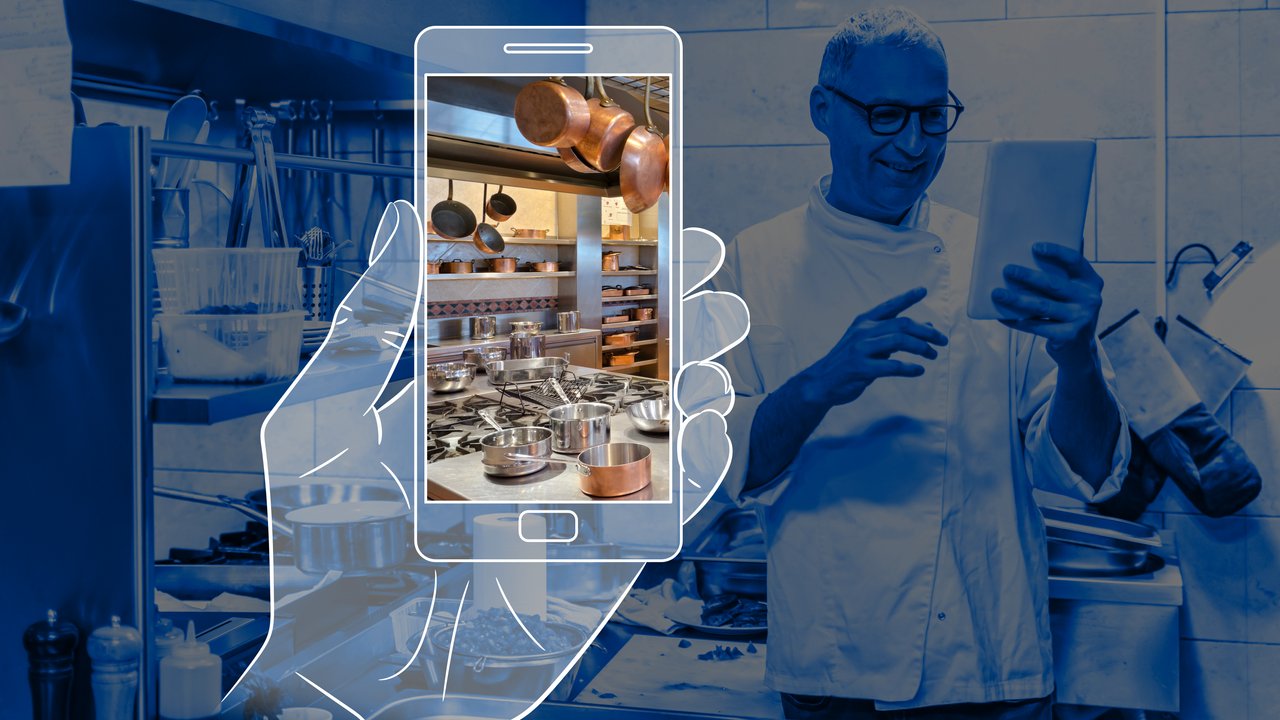 HSB Virtual Inspections Chef using mobile phone in restaurant kitchen to view virtual inspection