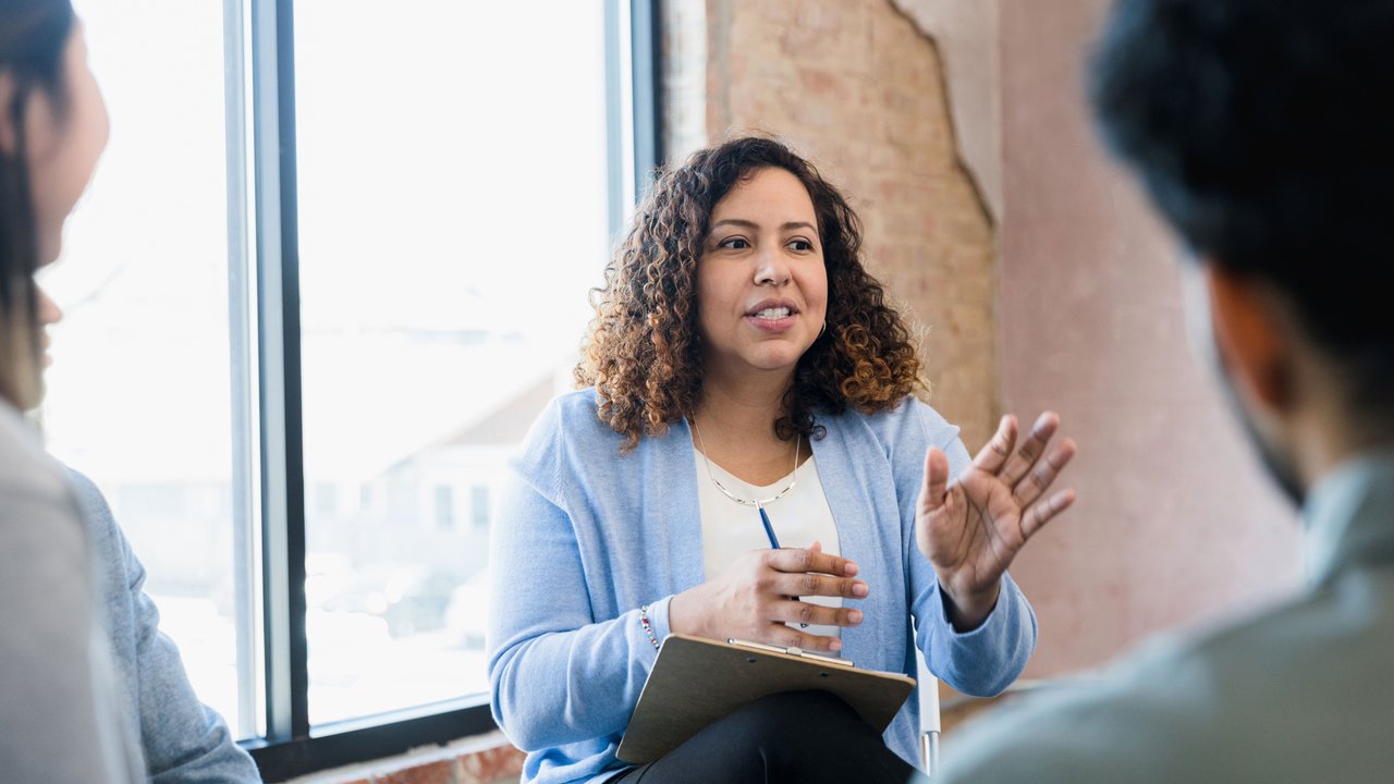 Professional female talking to peers
