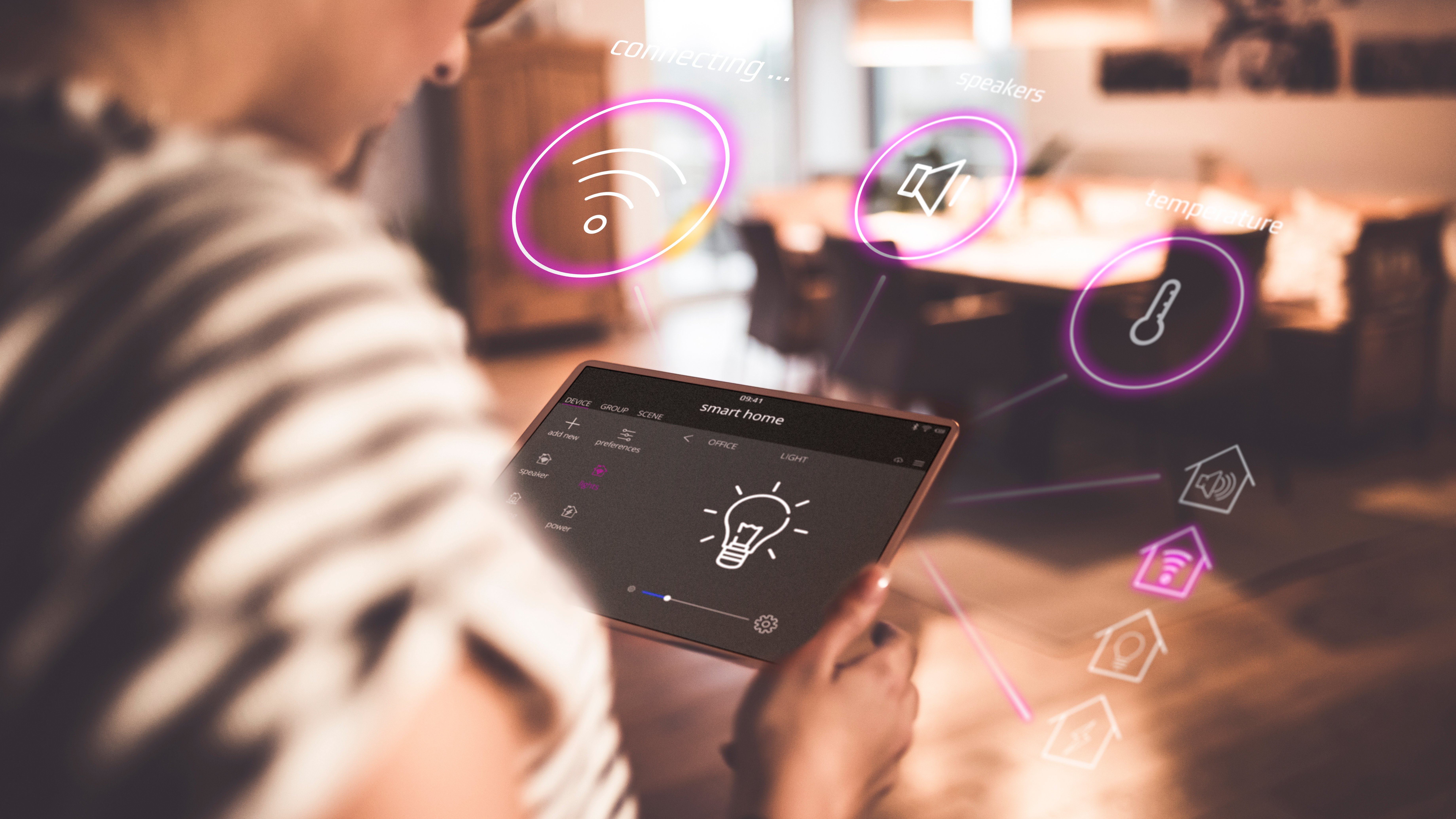 Person looking at computer tablet with digital graphic icons floating around it in air.