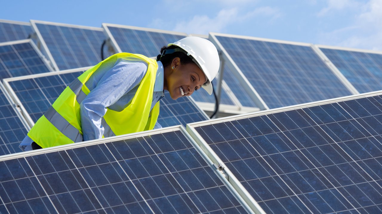 Female engineer with solar panels  - HSB Engineering Services