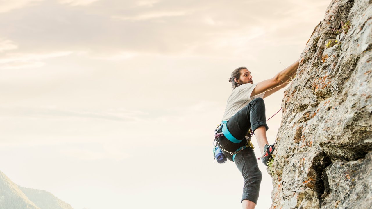 Caucasian man rock climbing