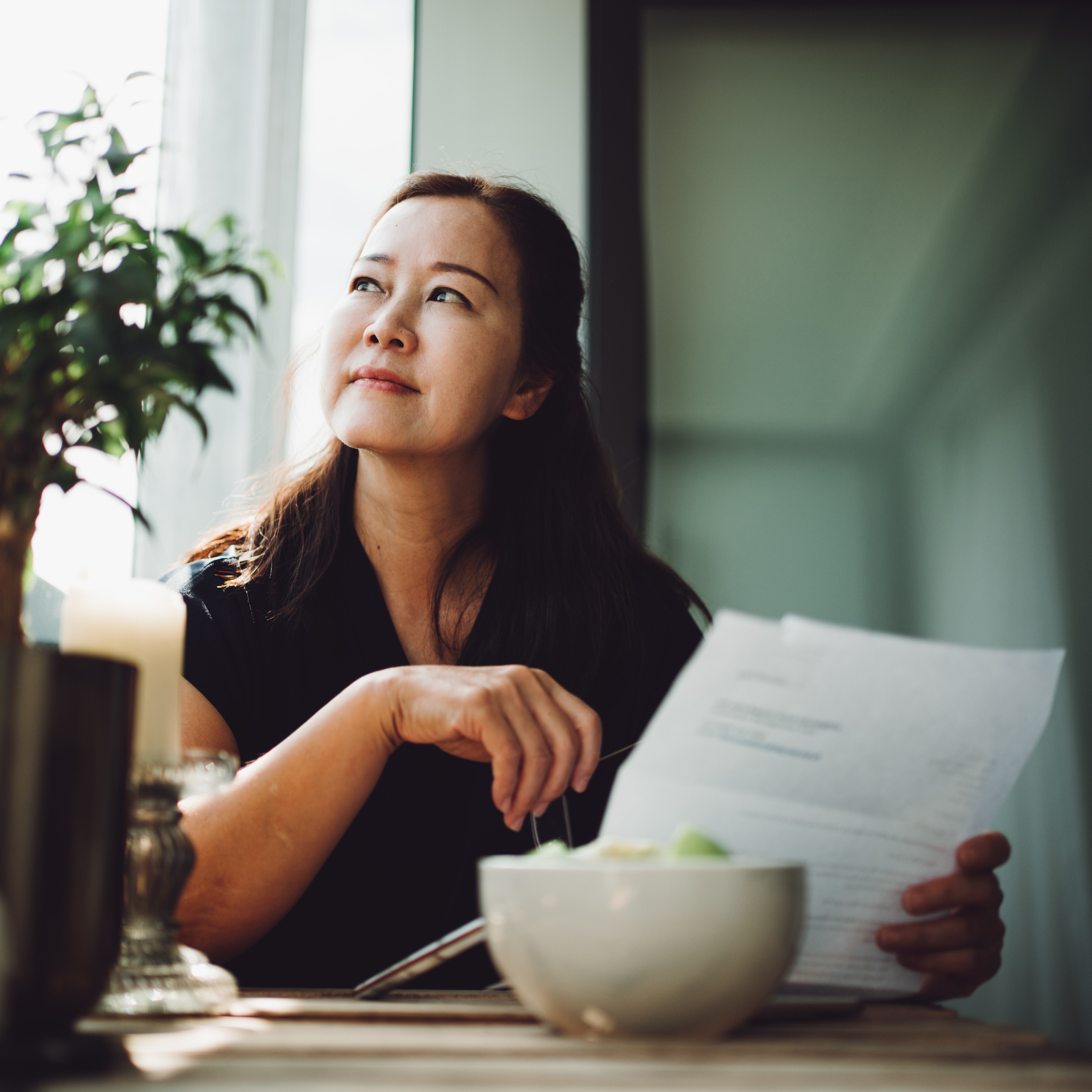 Asian senior woman working at home with a laptop stock photo