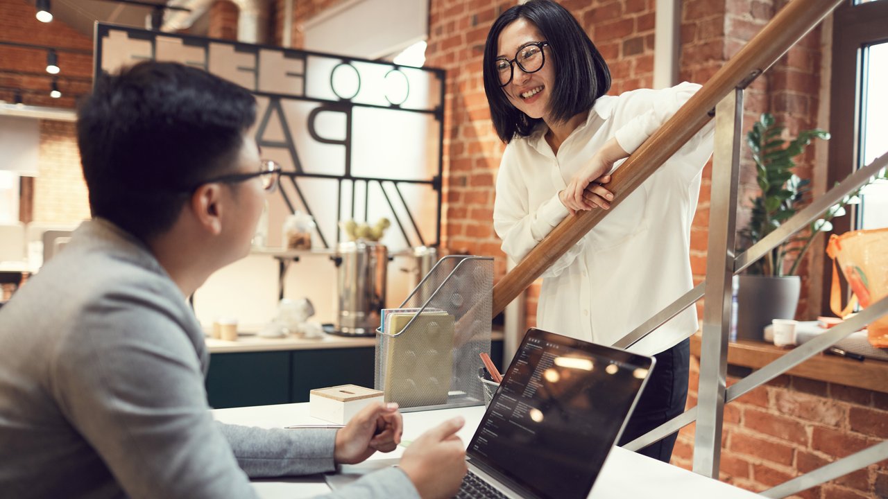 Businesswoman talking  with a colleague while working in modern office
