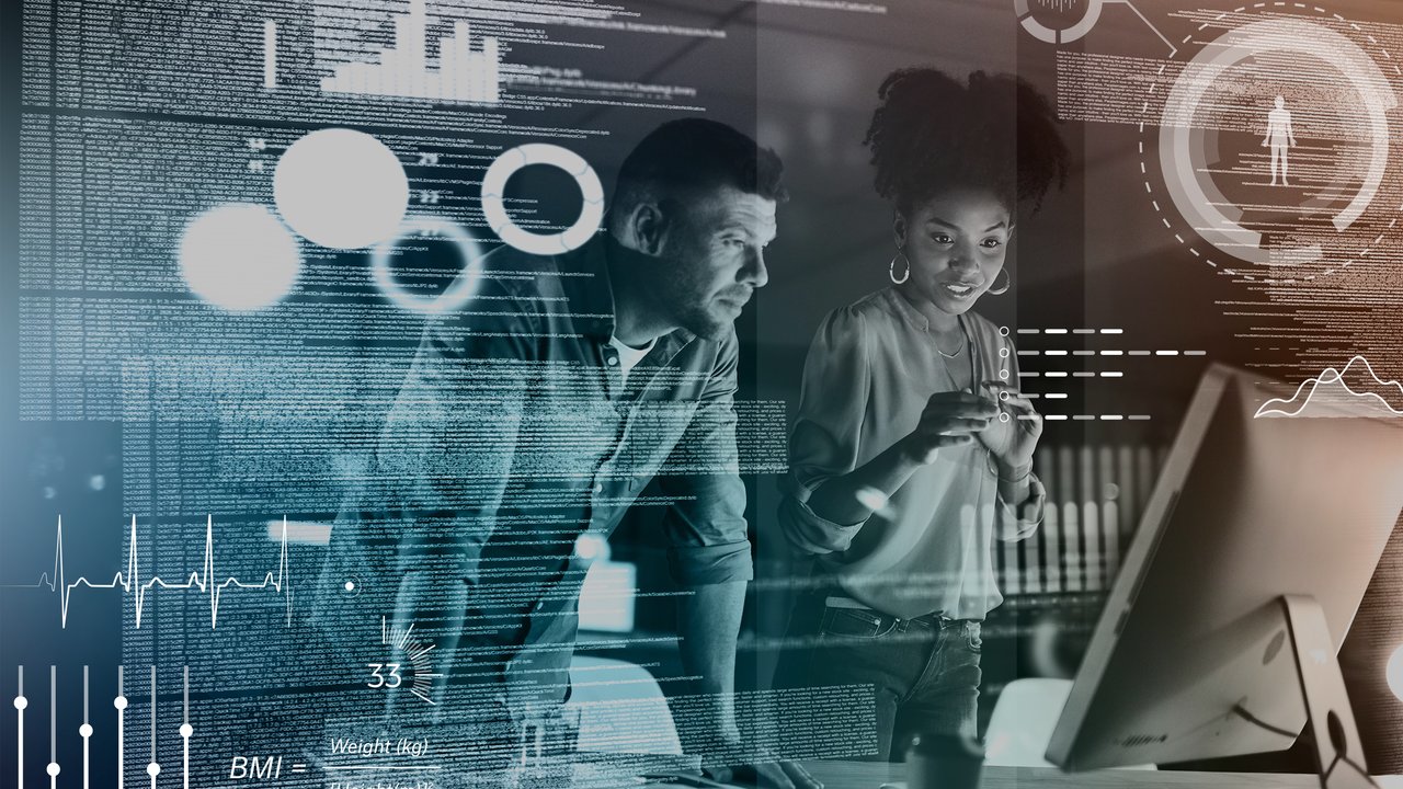 Two people looking at a computer screen.