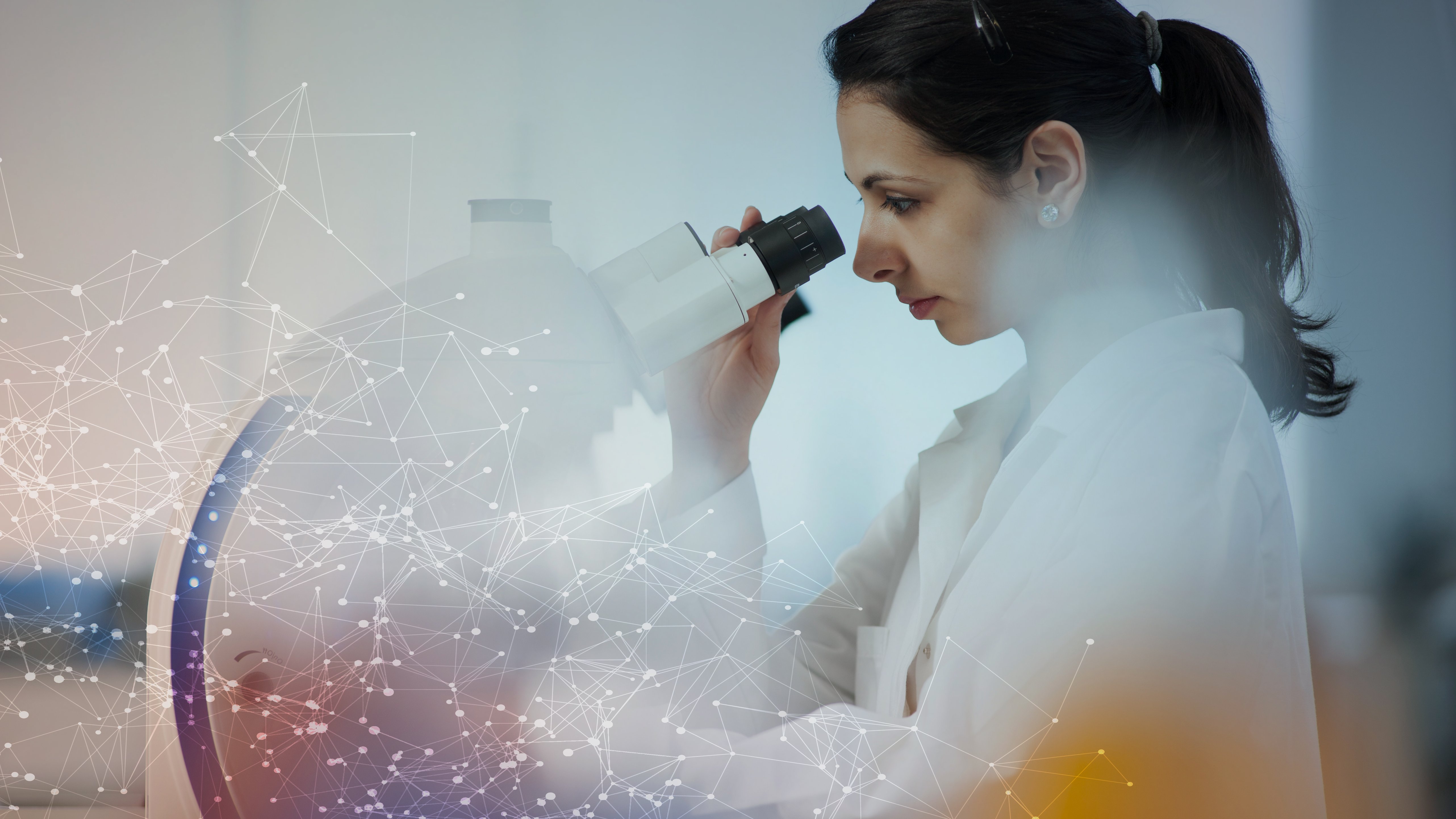 scientist using microscope in lab