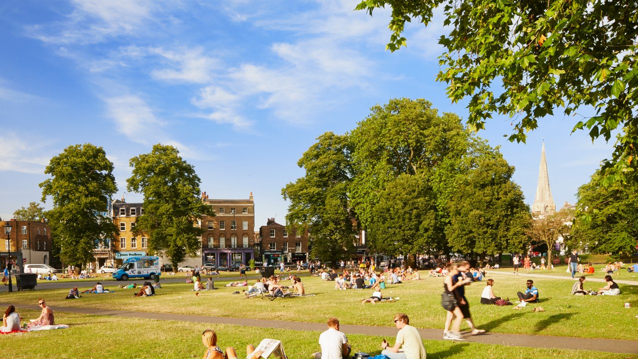 People relaxing in the sun Clapham Common London