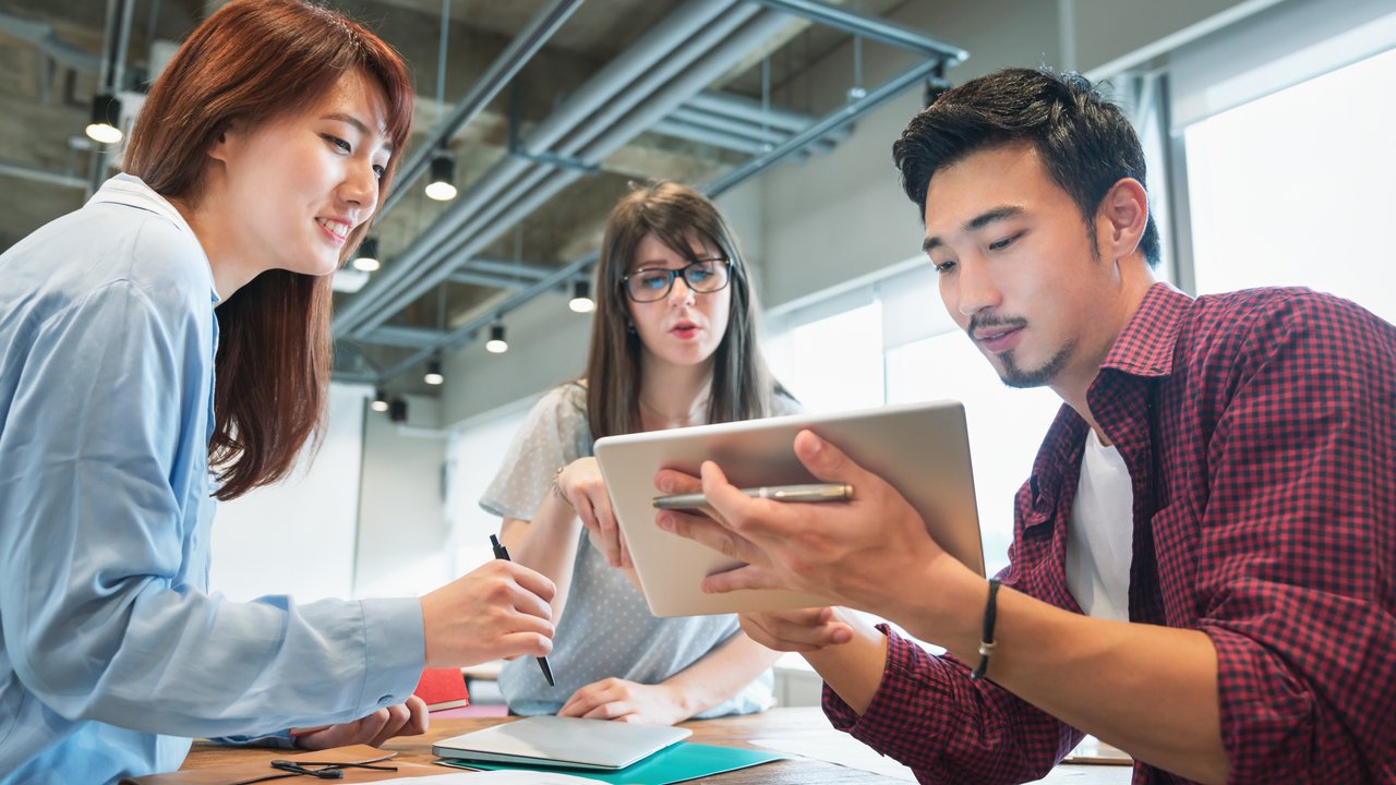 Creative people using laptop together