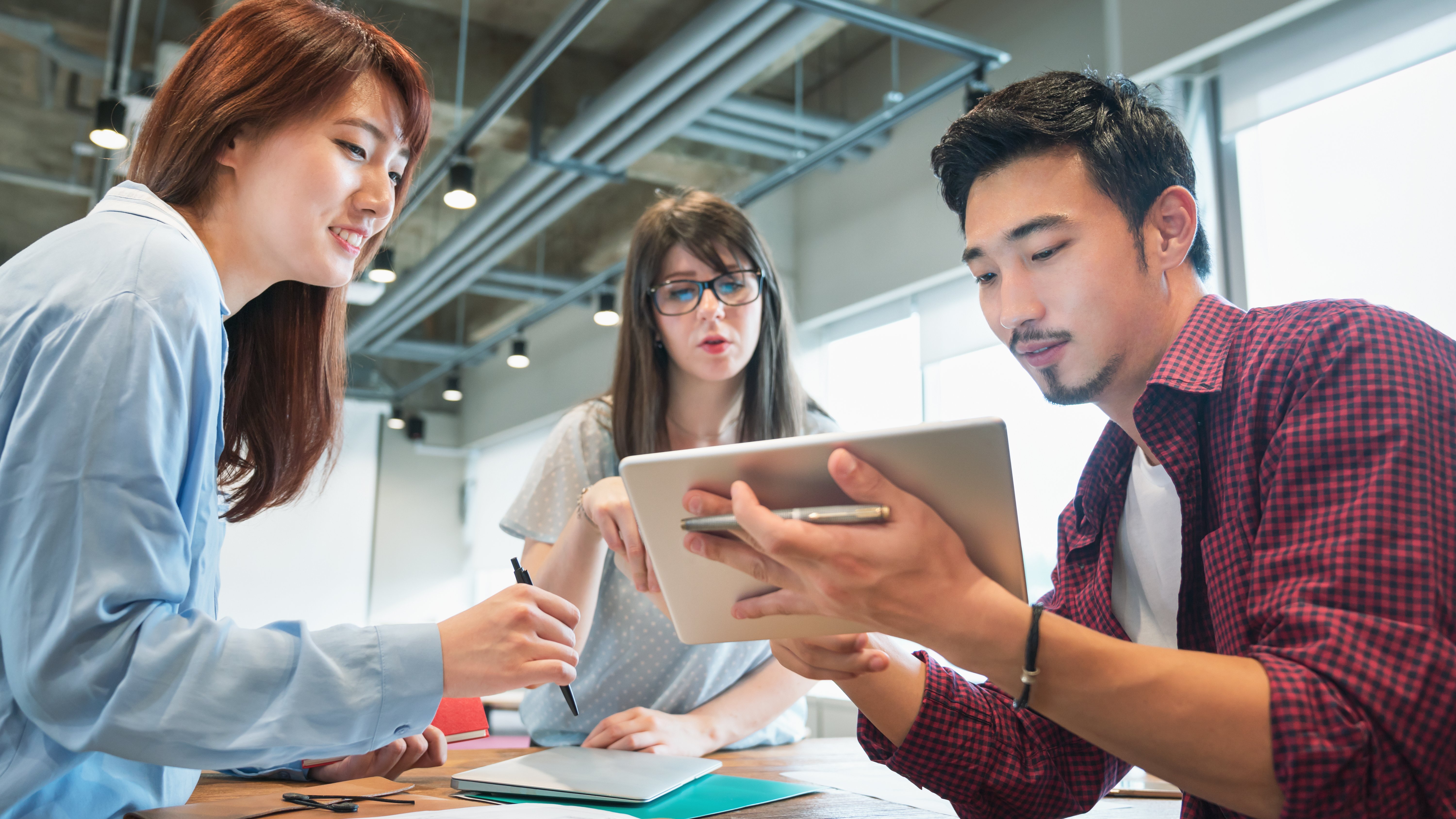 Colleagues discussing a project in the office Colleagues discussing a project in the office
