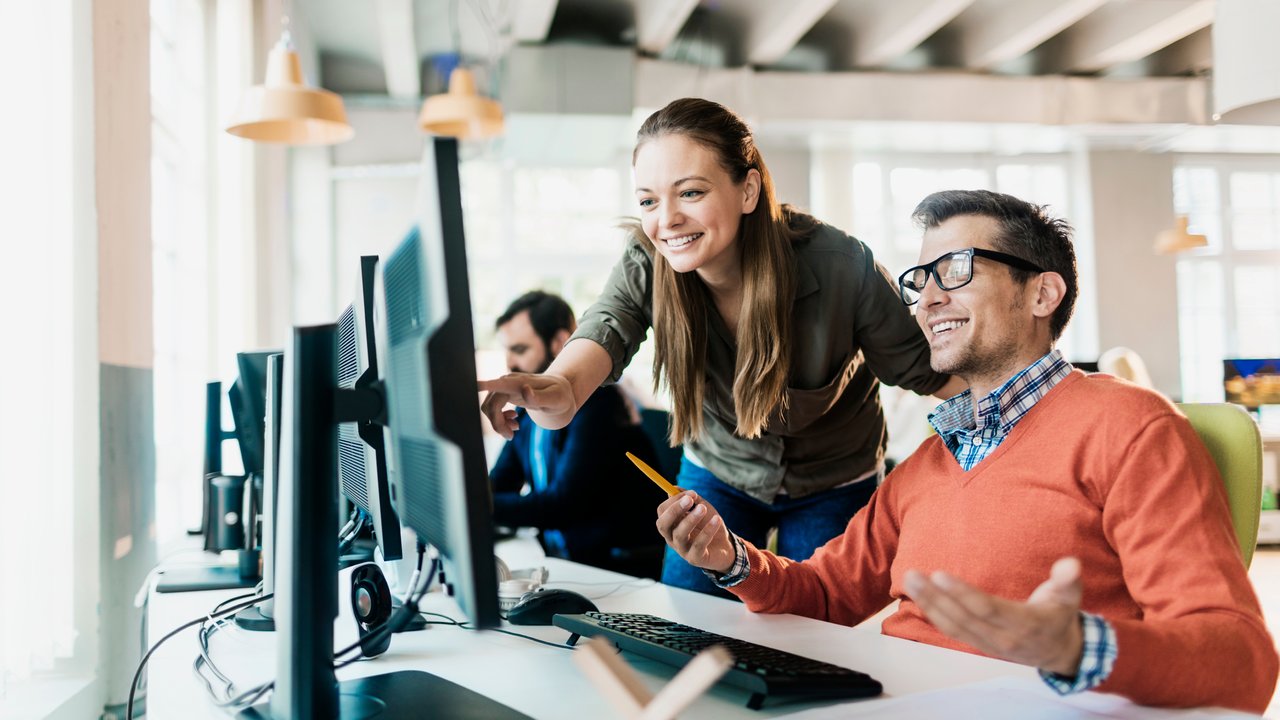 Creative people using laptop together