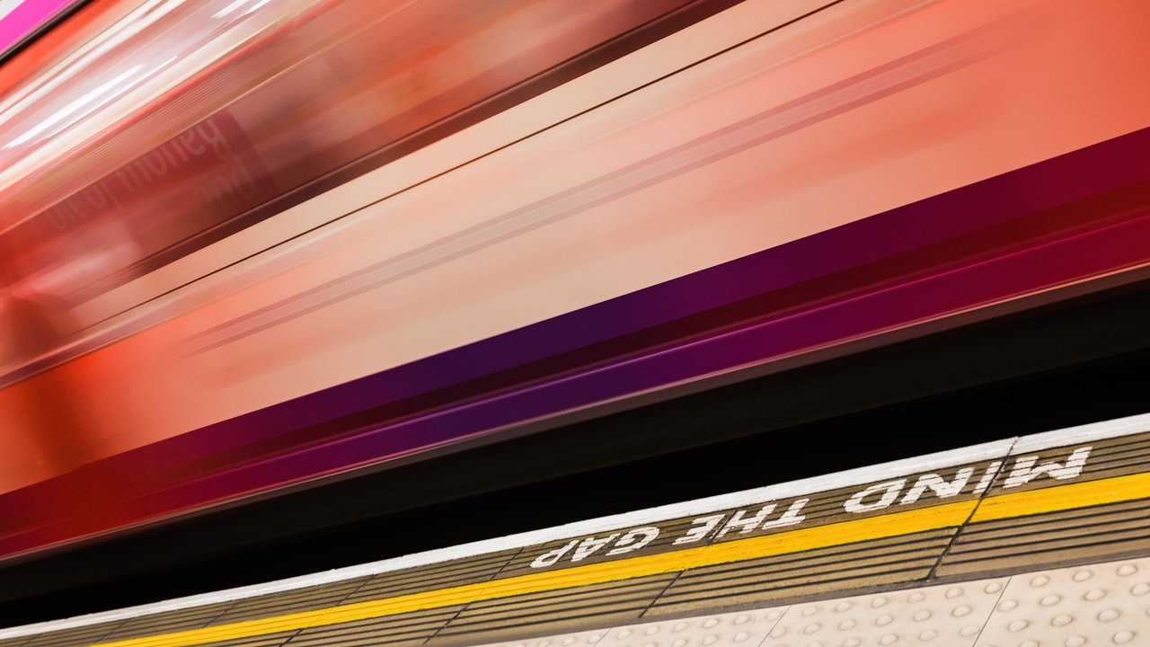 Global Cyber Risk and Insurance Survey 2026 A blurred image of a moving train with a warning sign reading "Mind the Gap" on the platform edge.