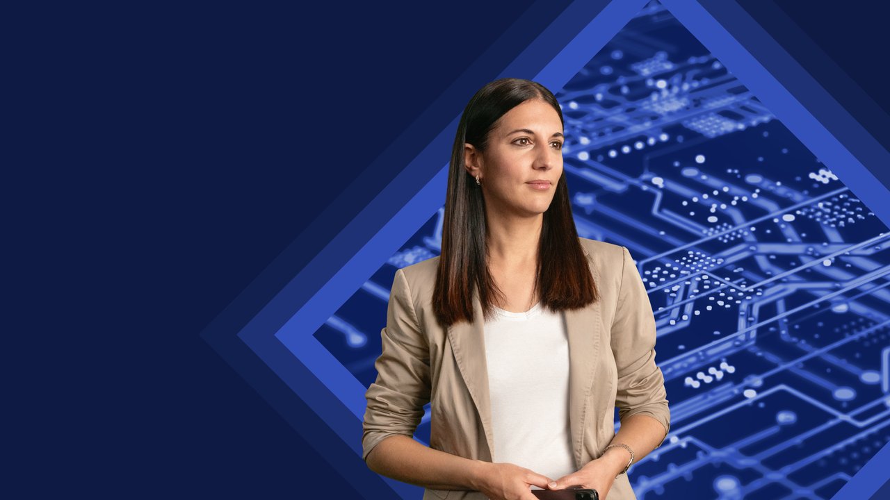 A woman in a beige blazer stands against a blue tech-themed background, holding a smartphone.