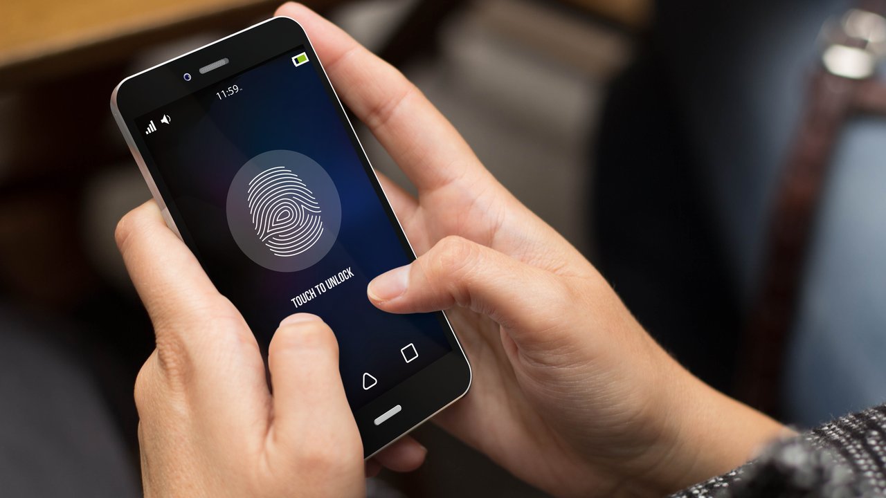 Digital transformation – an opportunity for insurance markets in Latin America biometric security concept: girl unlocking a digital generated phone. All screen graphics are made up.
