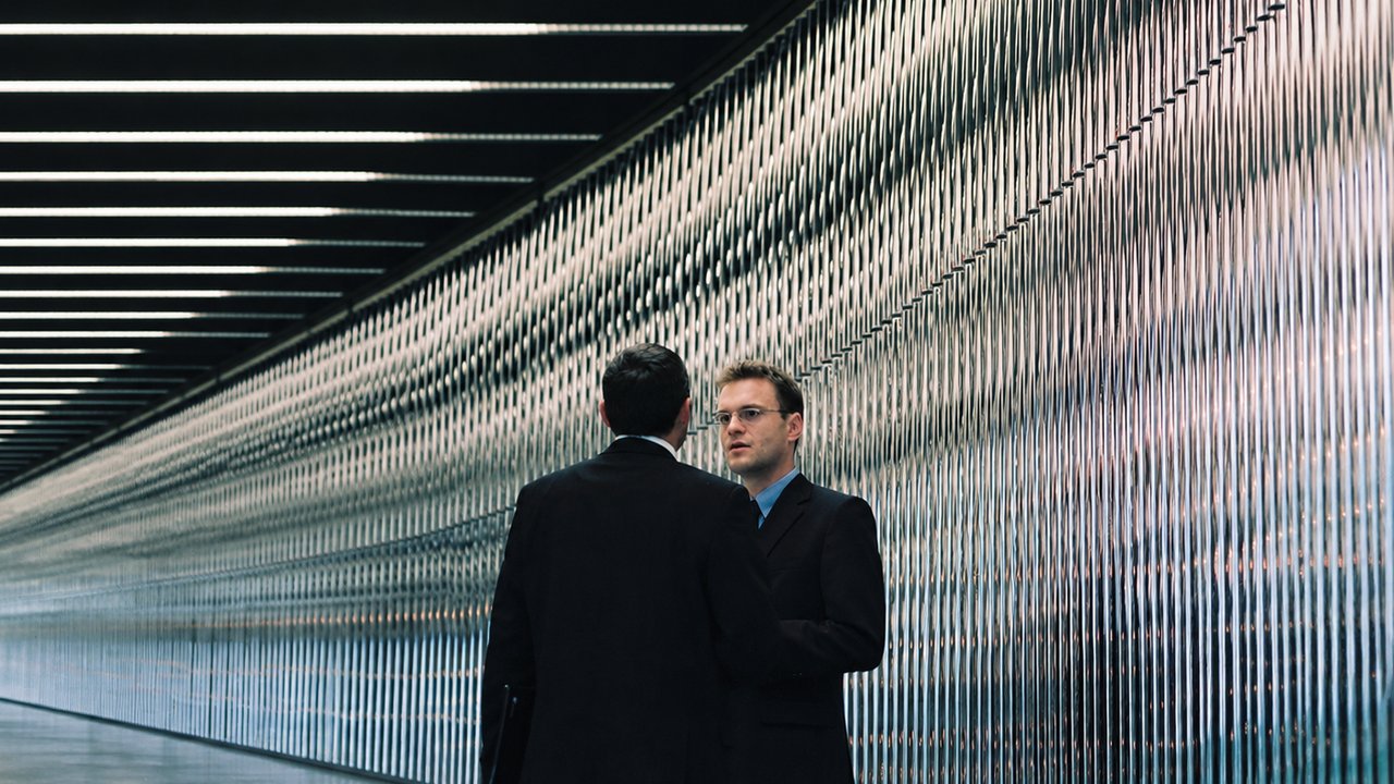 Two people talking in Munich Re Main Building