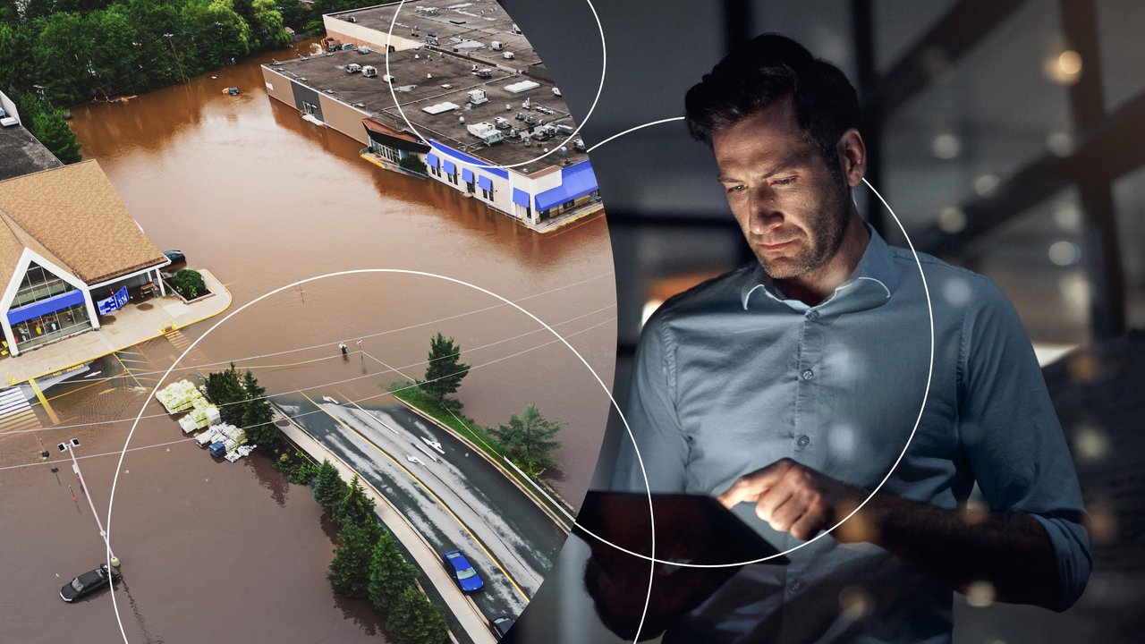 Aerial view of flooded commercial buildings and a person using a tablet indoors.